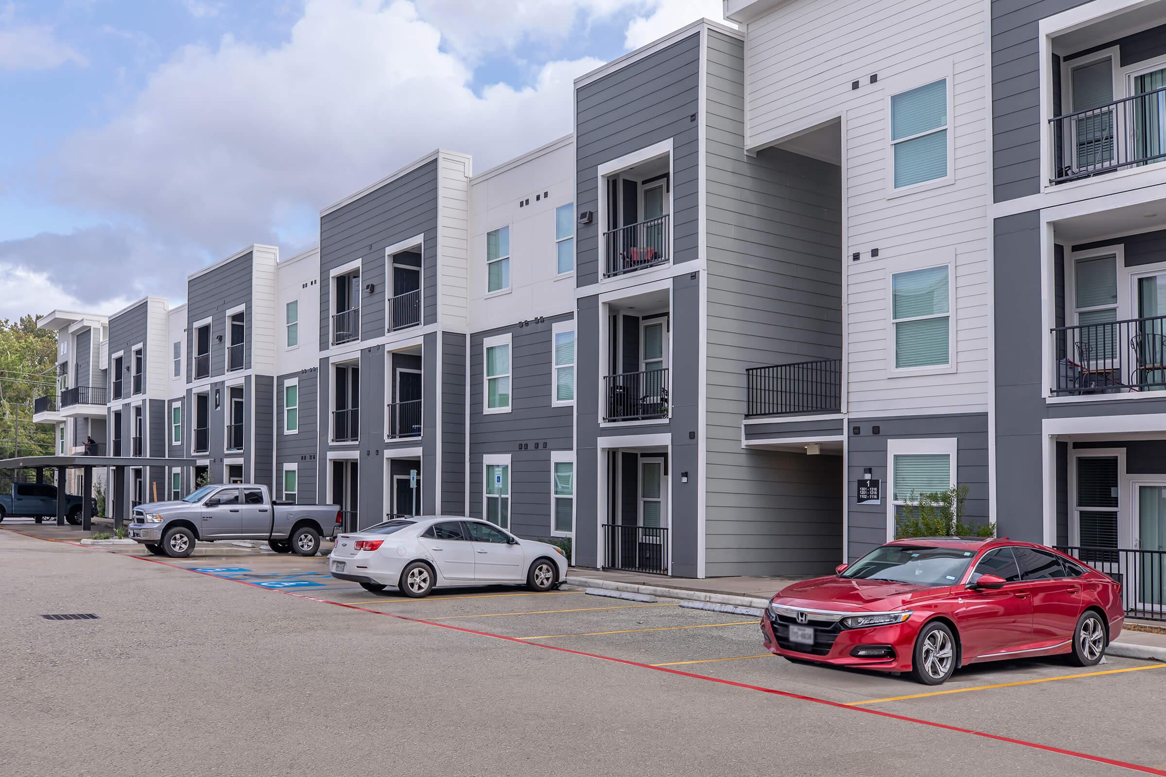 a car parked in a parking lot in front of a building