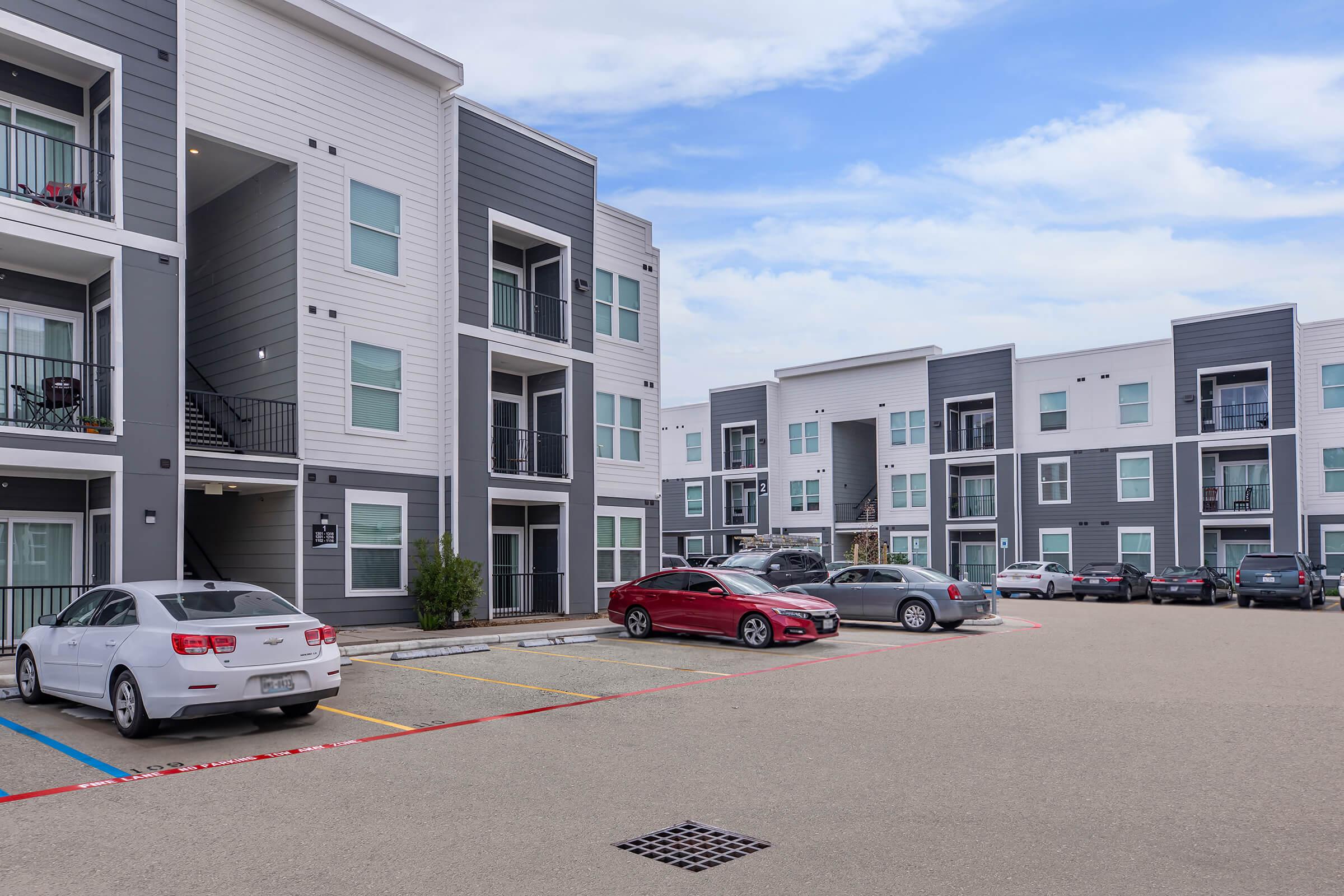 a car parked in a parking lot in front of a building