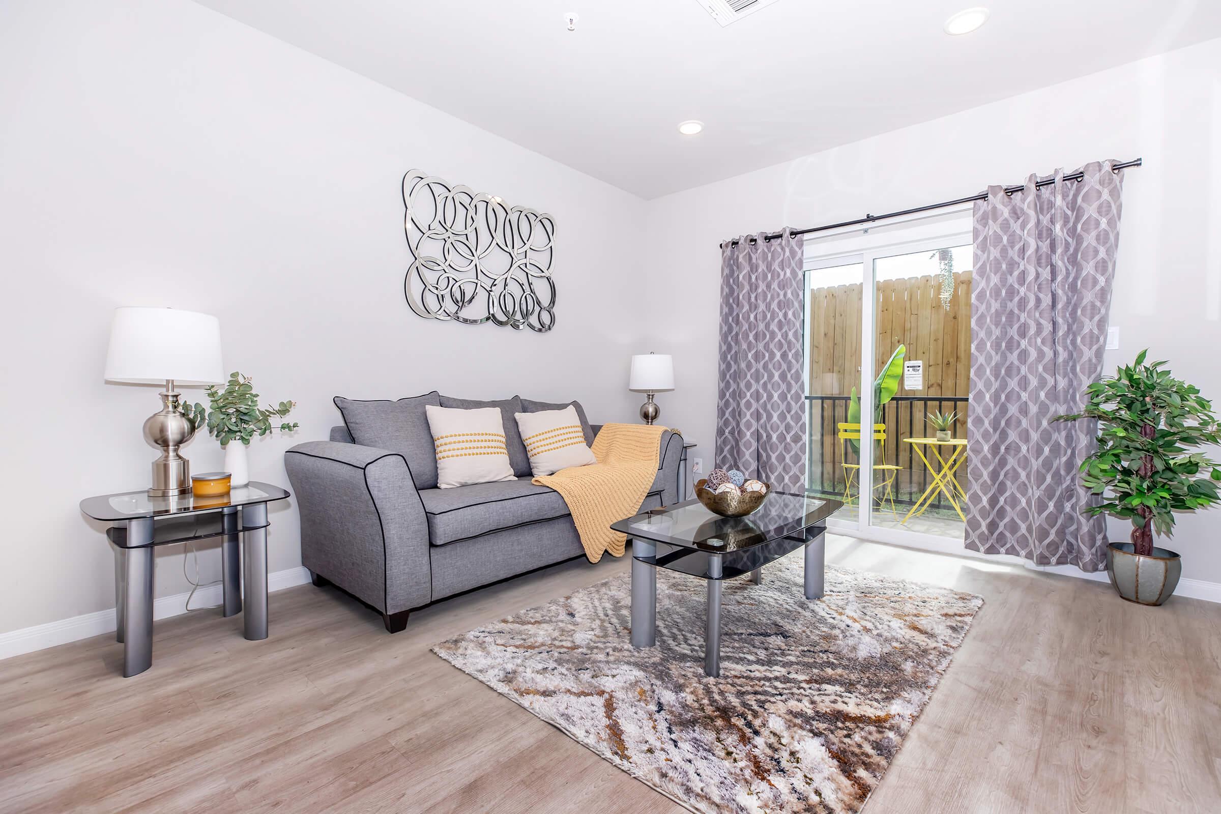 a living room filled with furniture and a flat screen tv