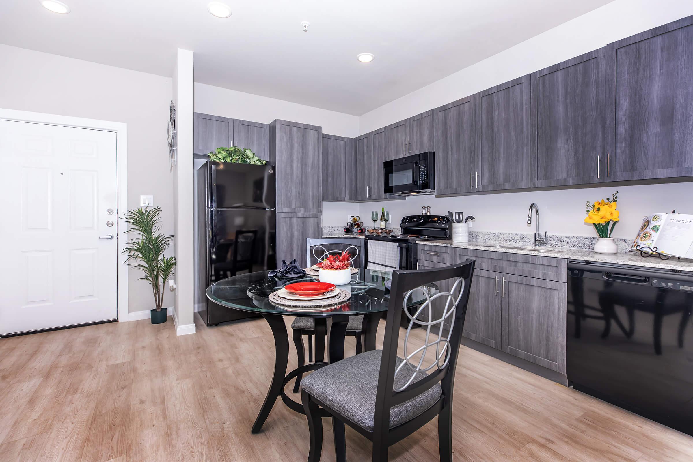 a kitchen with a table and chairs in a room