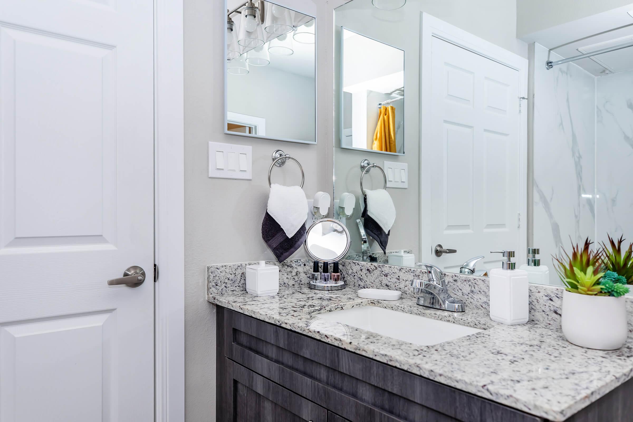 a kitchen with a sink and a mirror