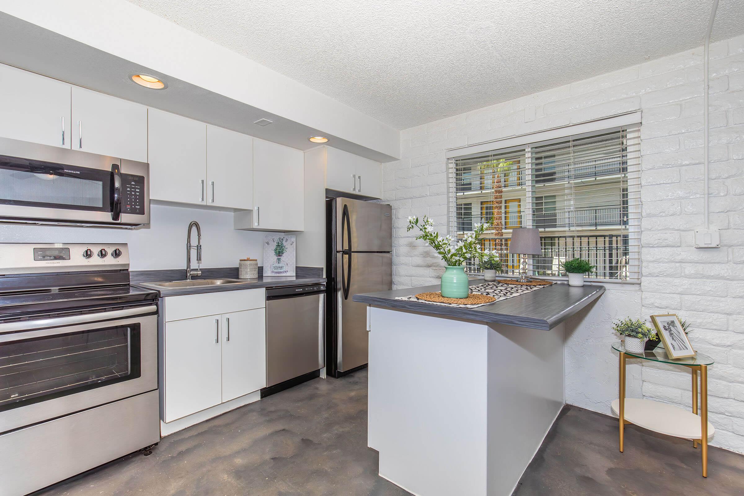 a kitchen with a stove top oven sitting inside of a room