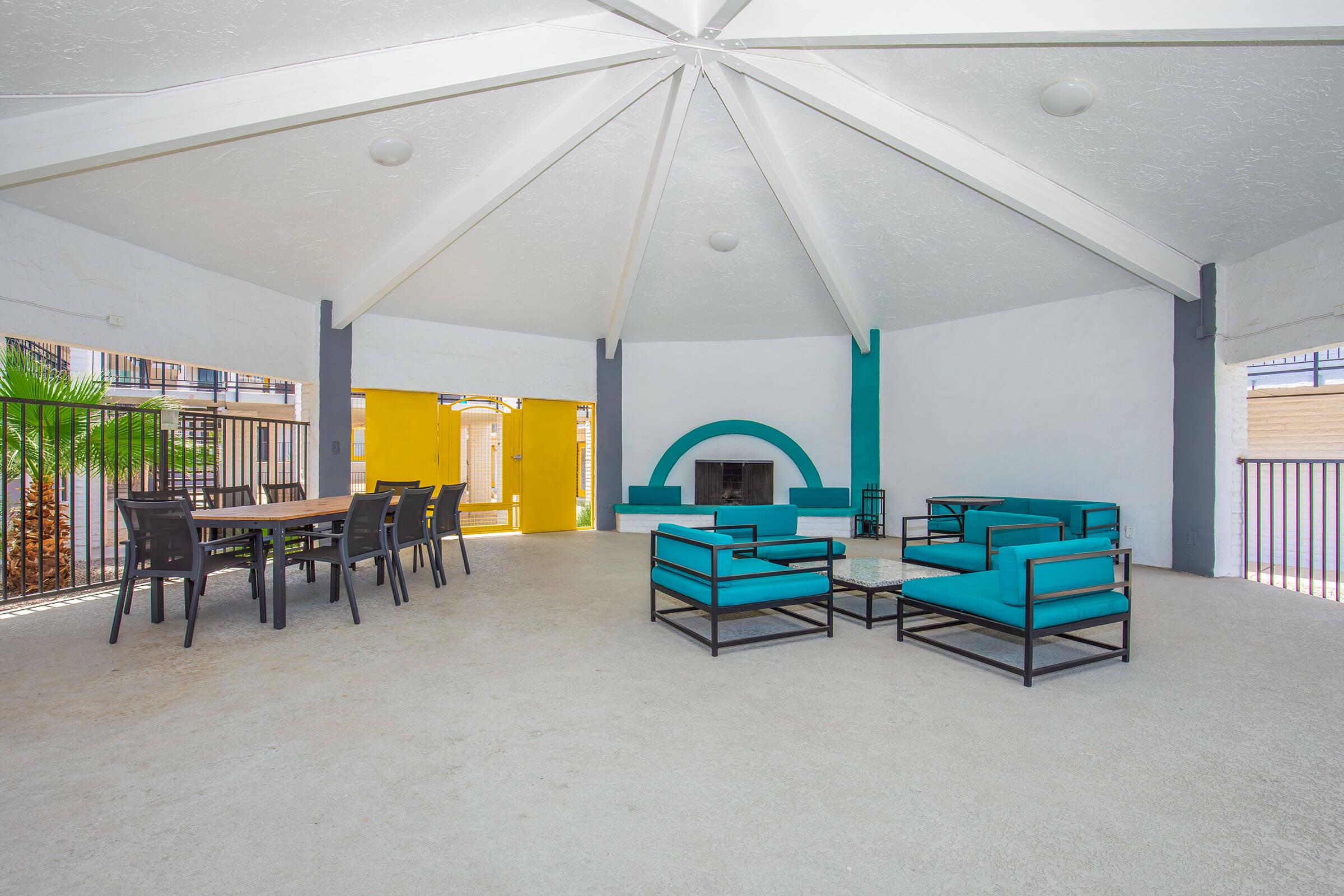 a group of people in a room with a blue umbrella