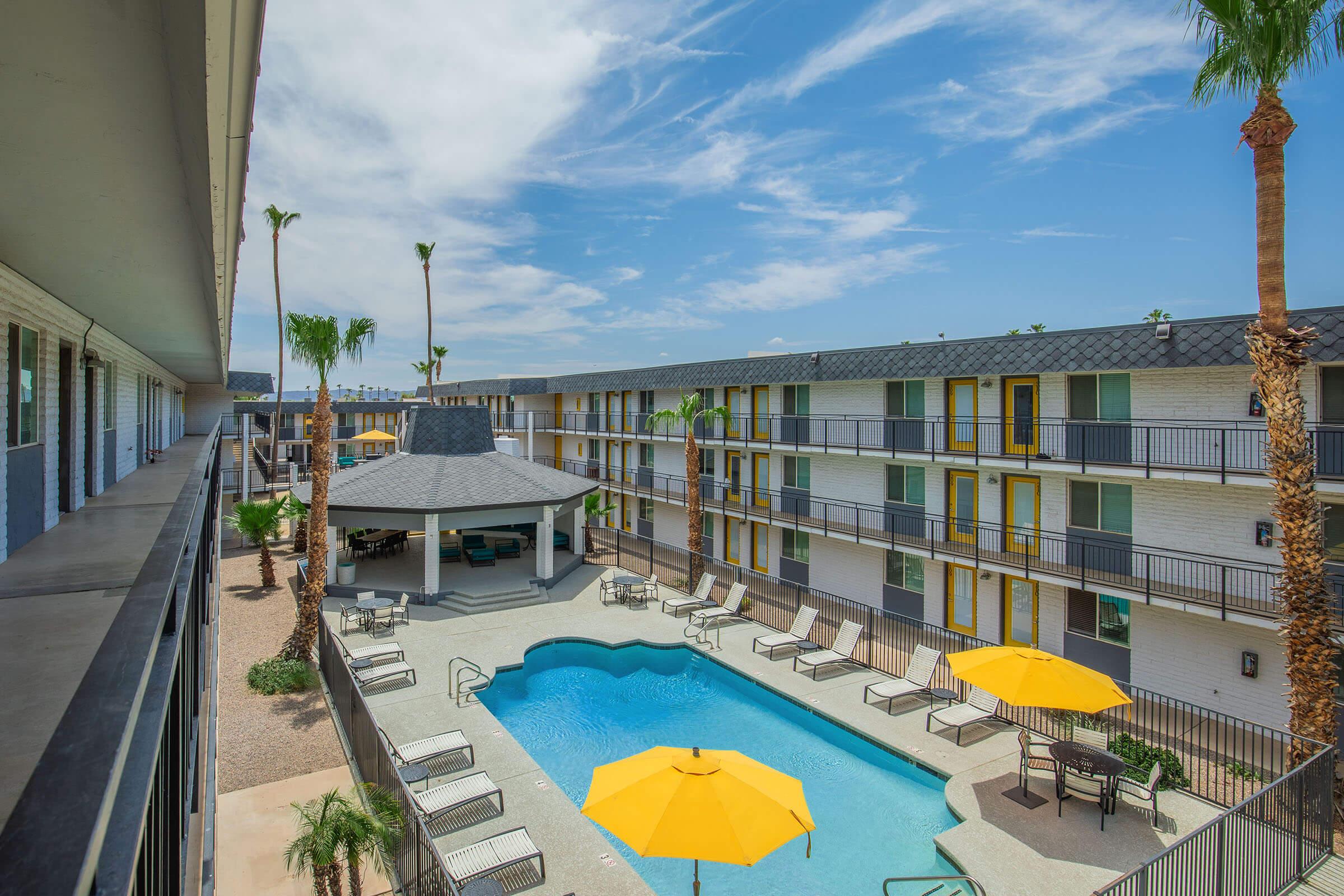 a building that has a umbrella in a pool