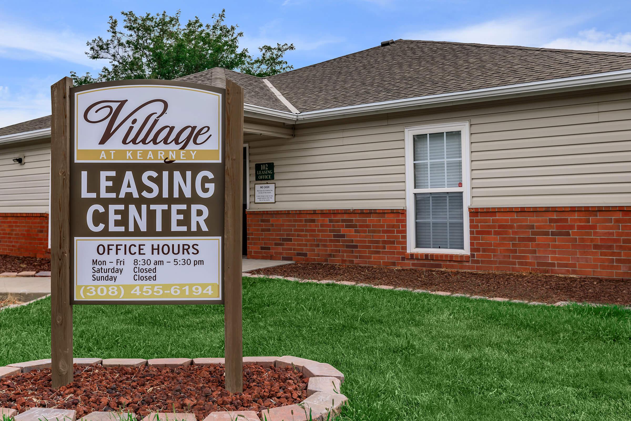 a sign in front of a house