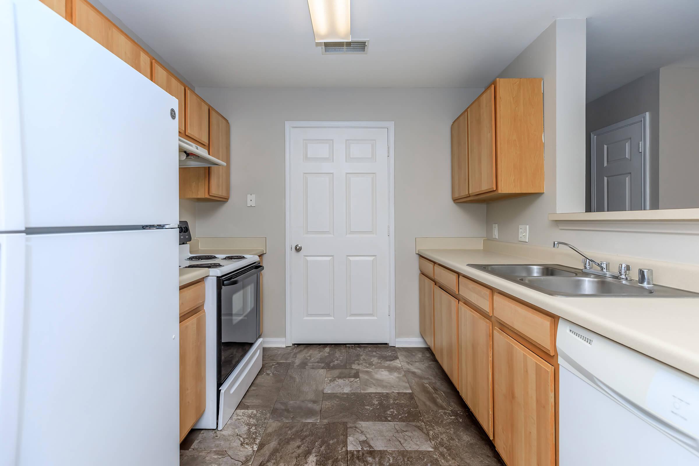 a kitchen with a sink and a refrigerator