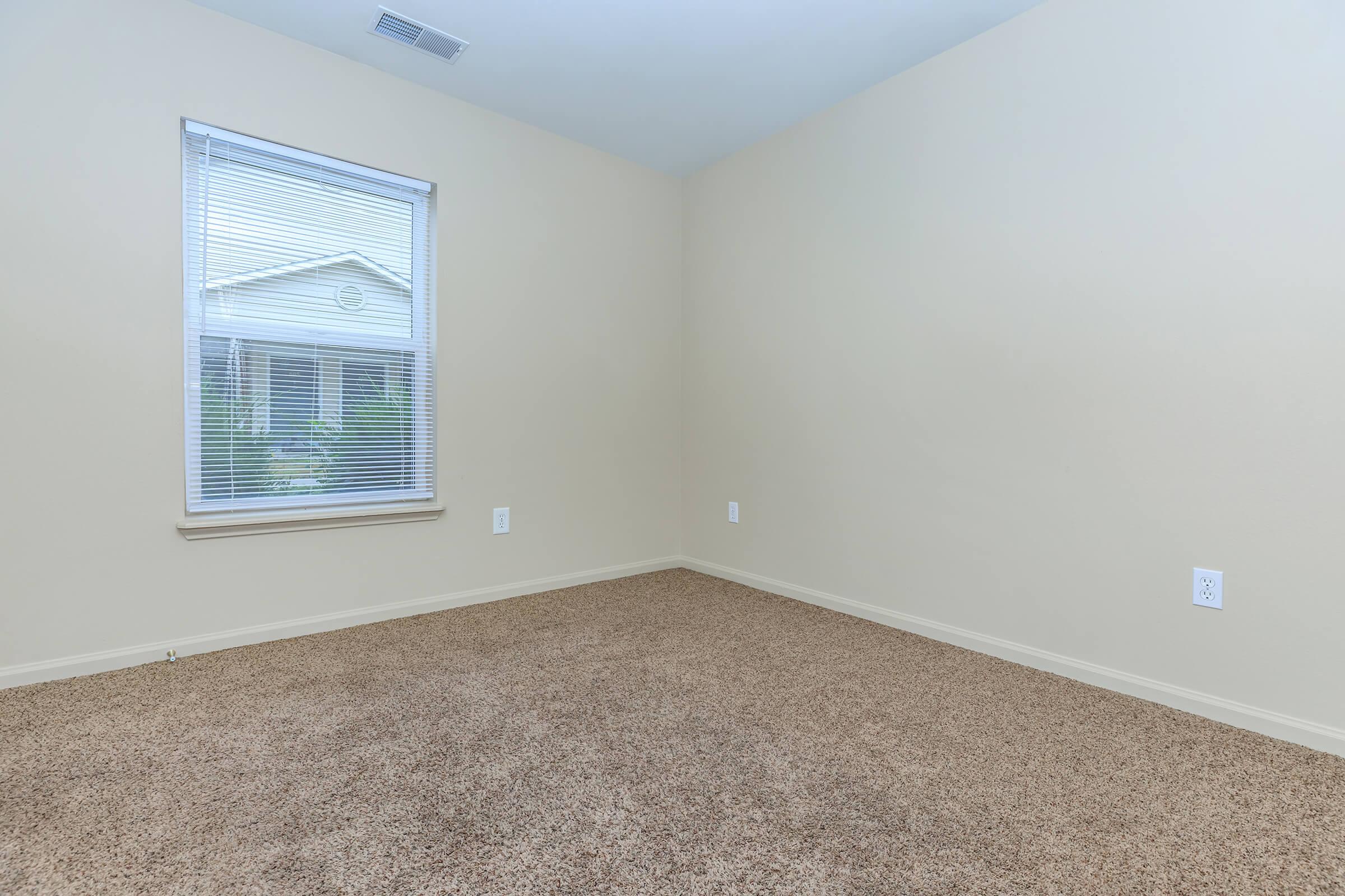 a close up of a bedroom next to a window