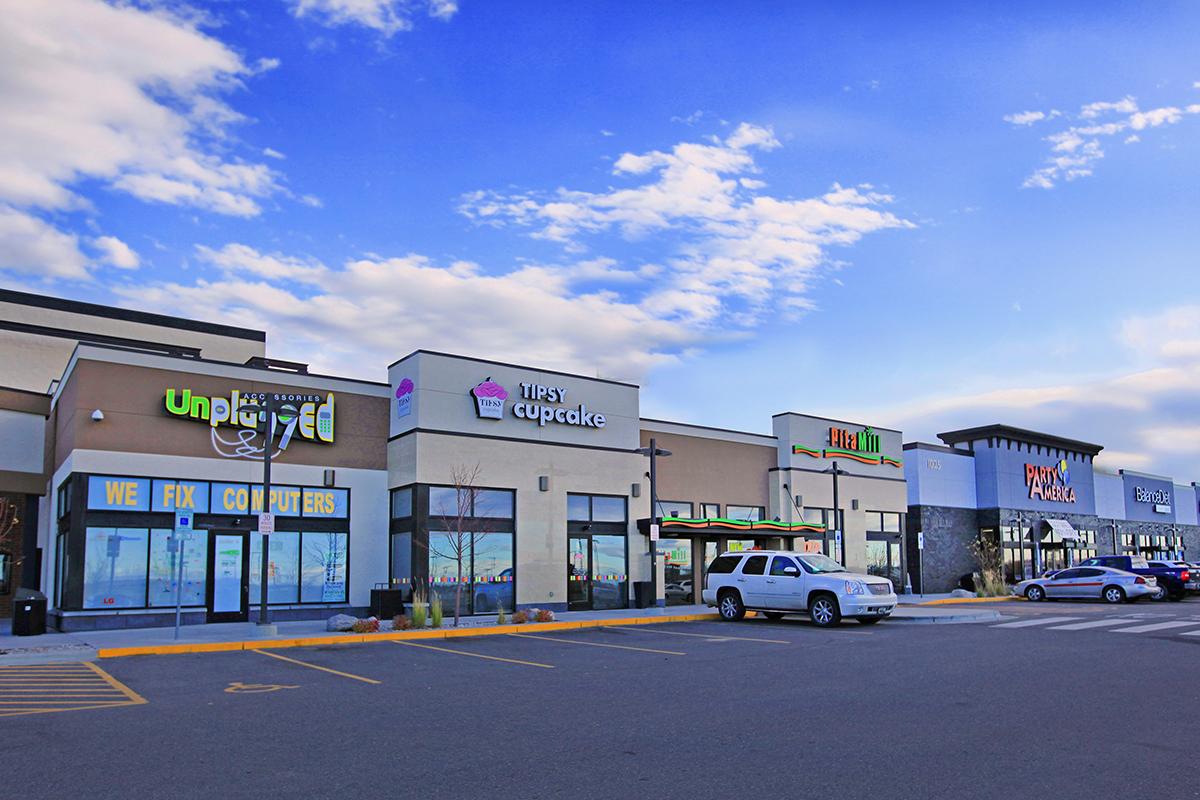 a sign above a store in a parking lot