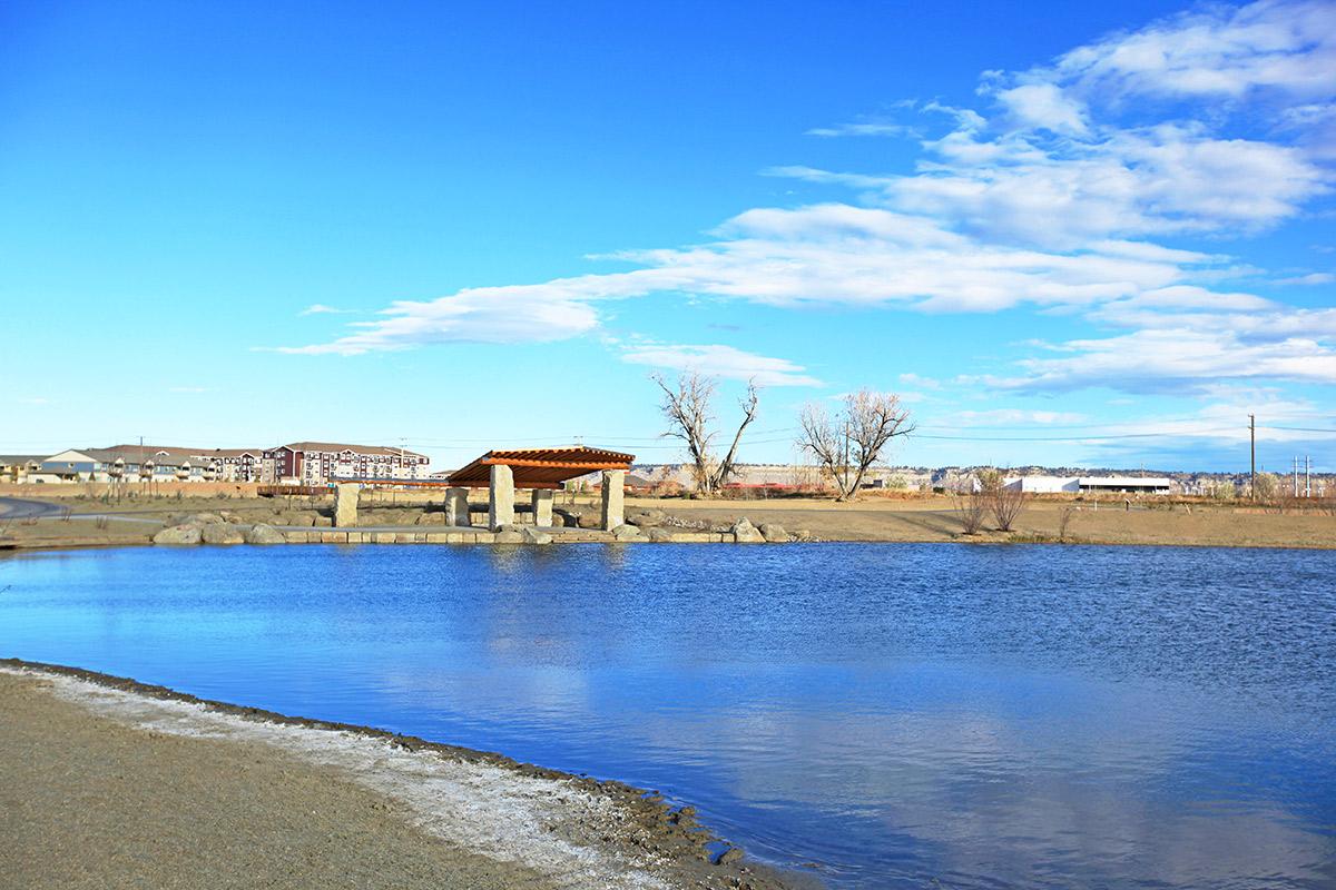 a sandy beach next to a body of water