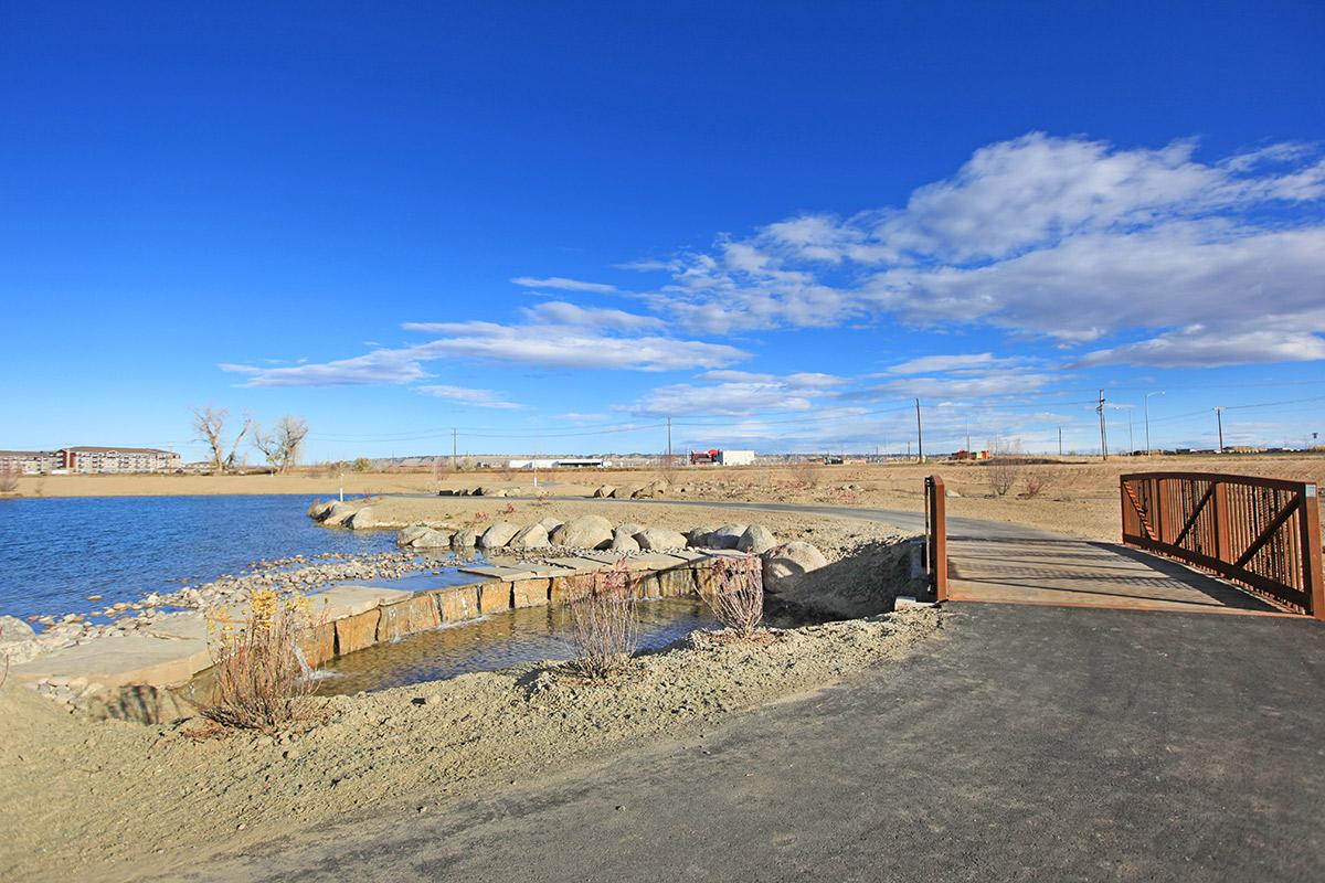 a sandy beach next to a body of water