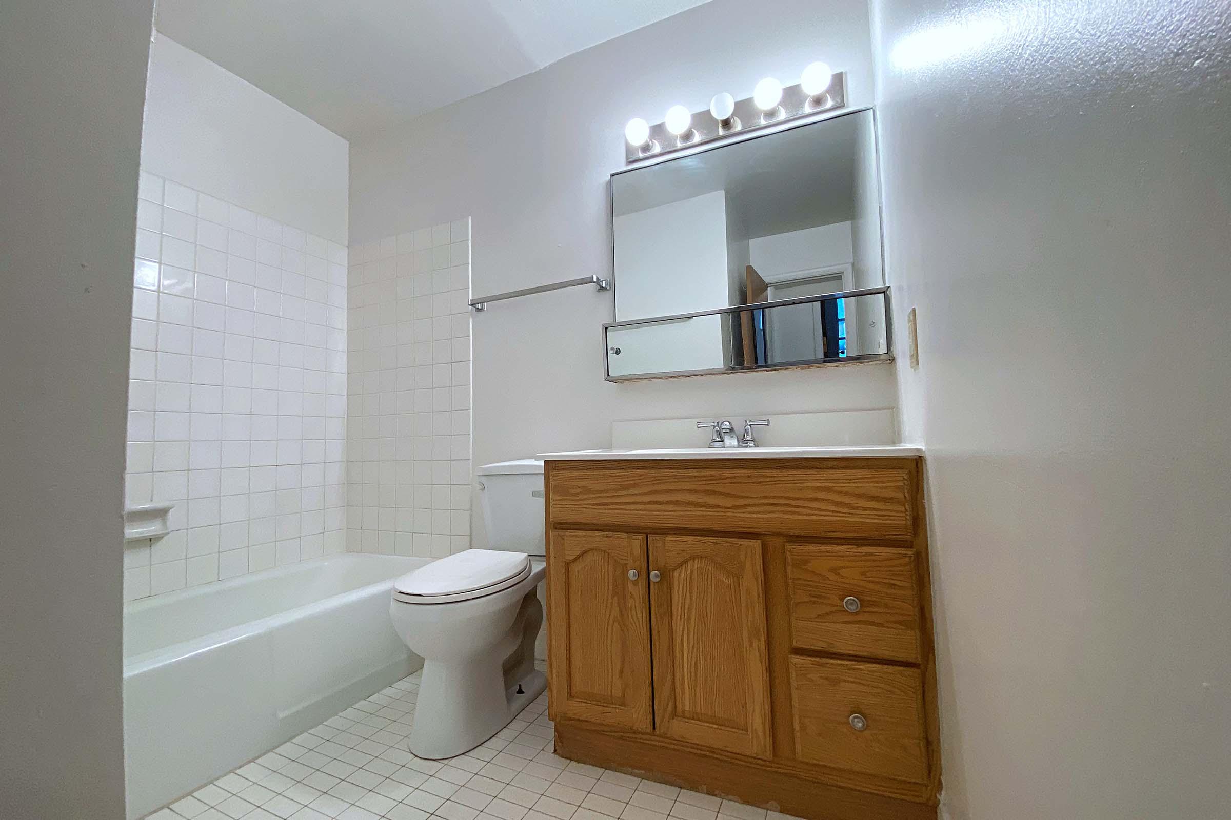 a kitchen with a sink and a mirror