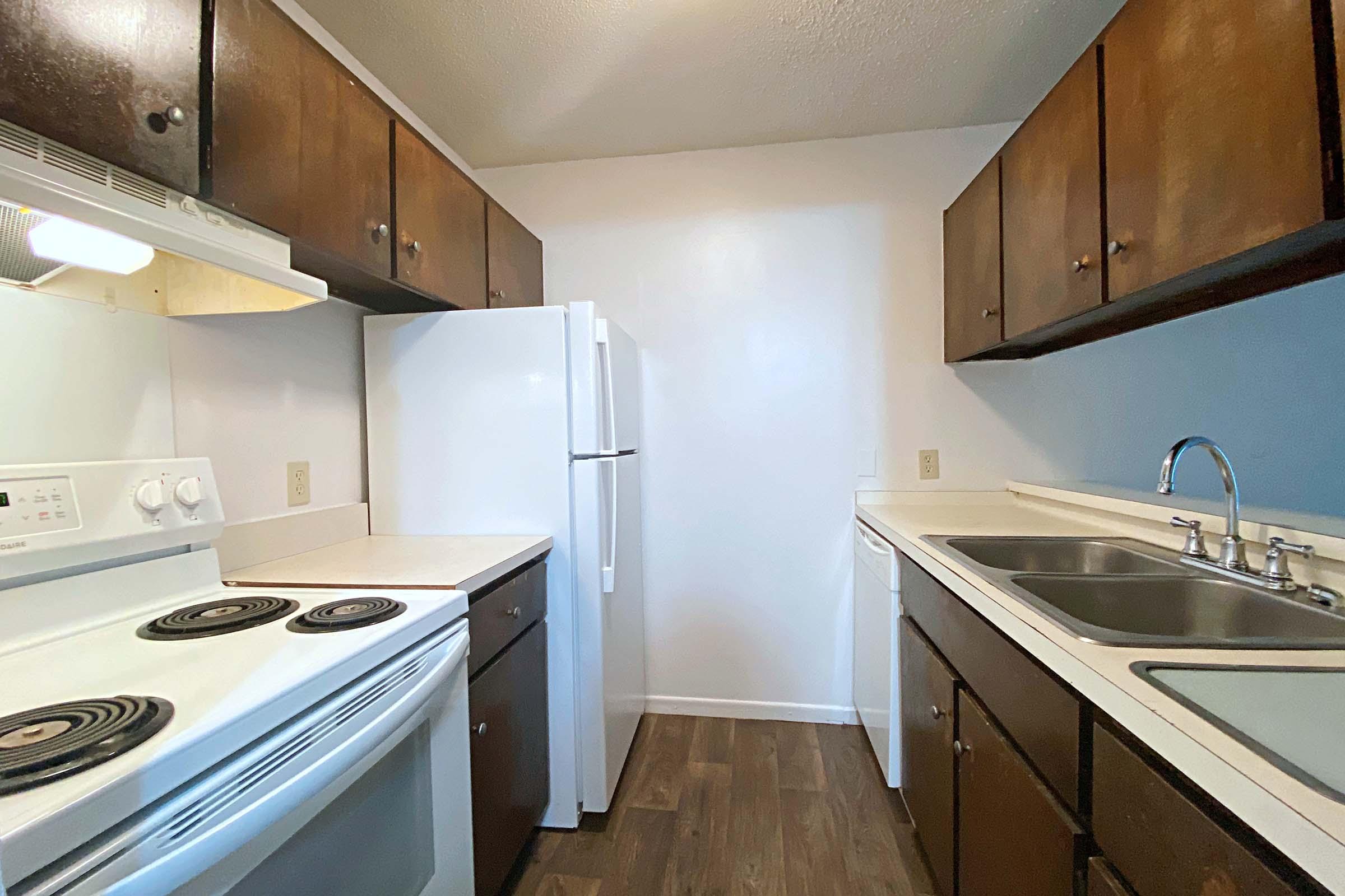 a kitchen with stainless steel appliances and wooden cabinets