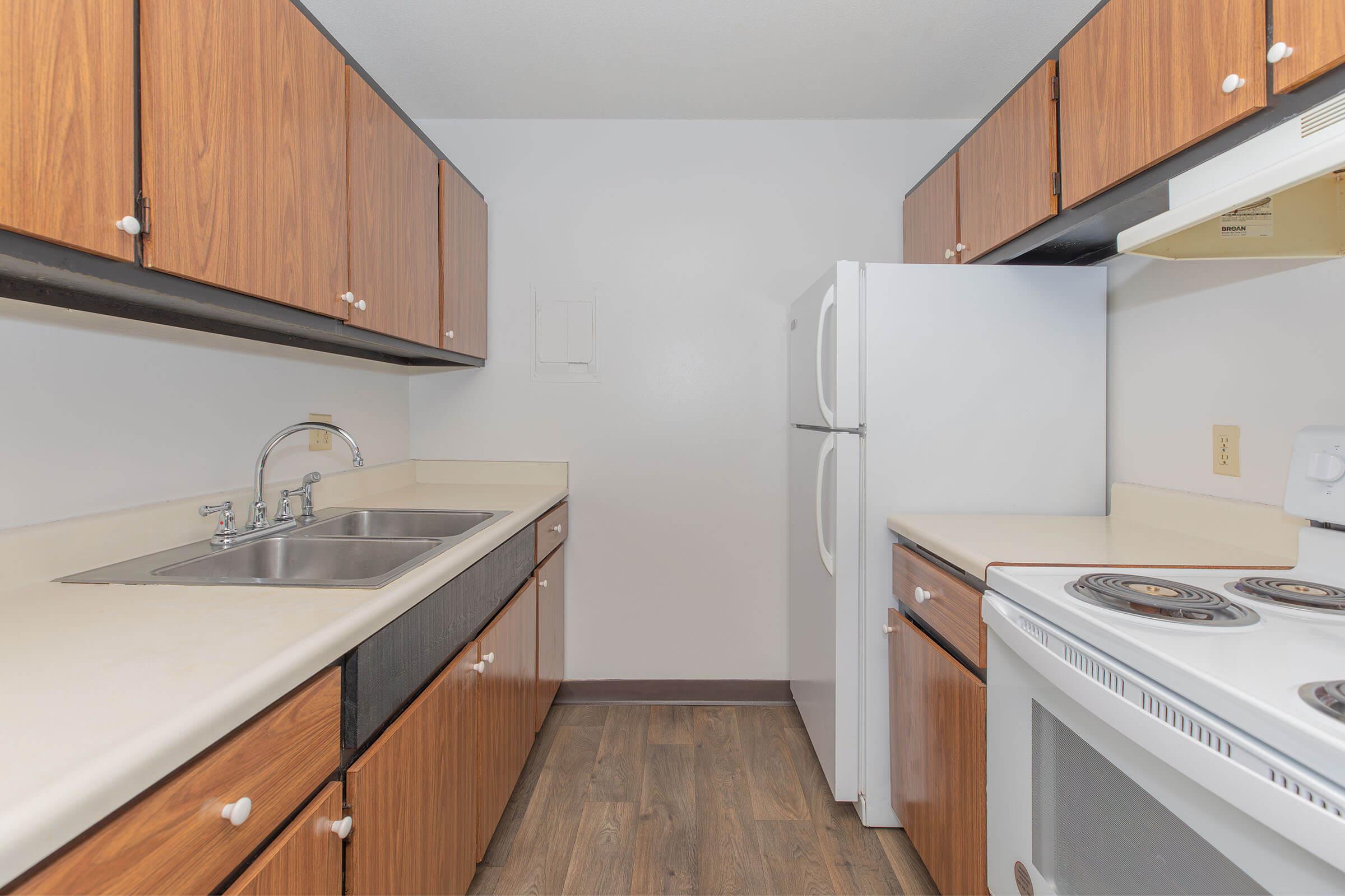 a kitchen with a stove sink and refrigerator