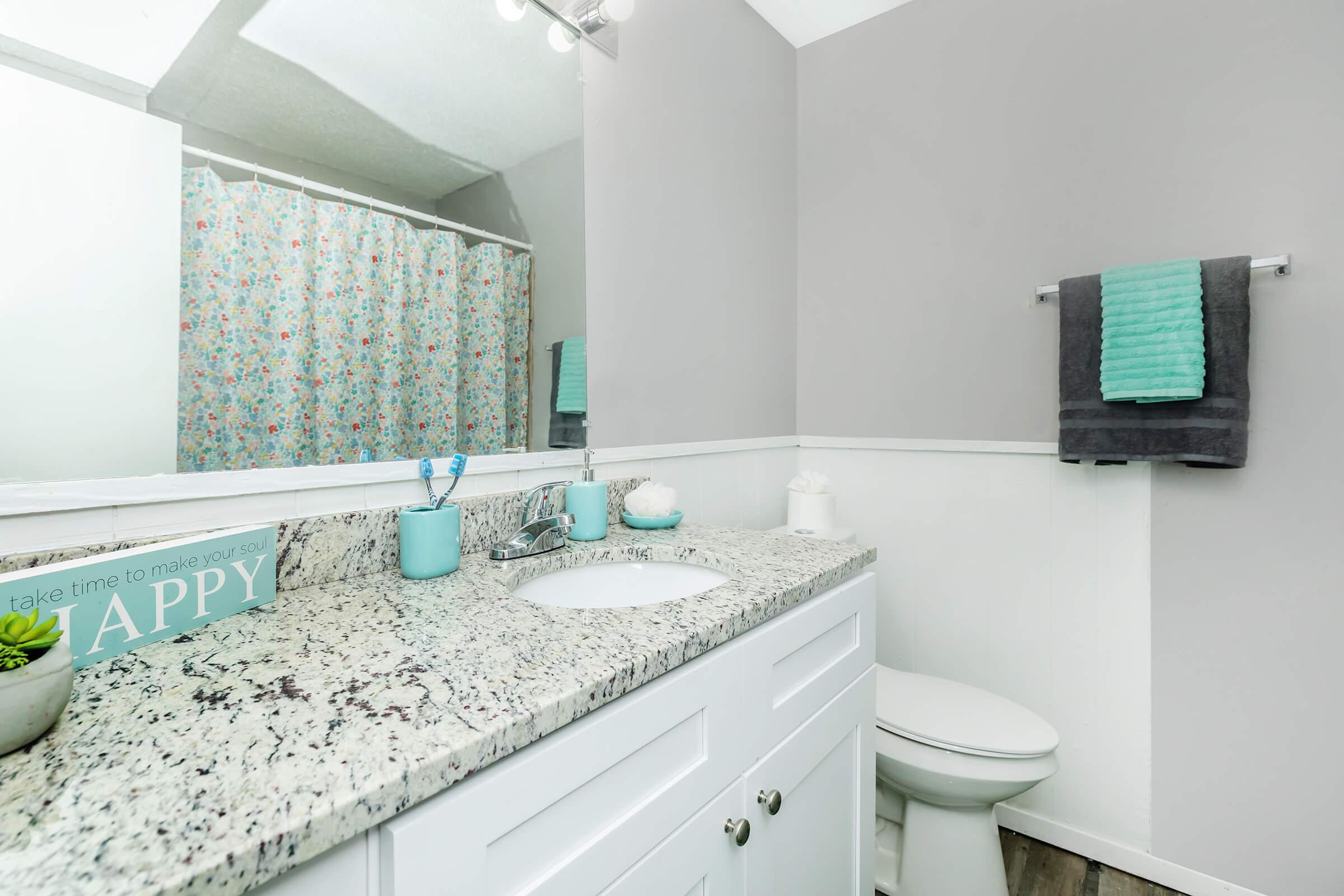 a kitchen with a sink and a mirror