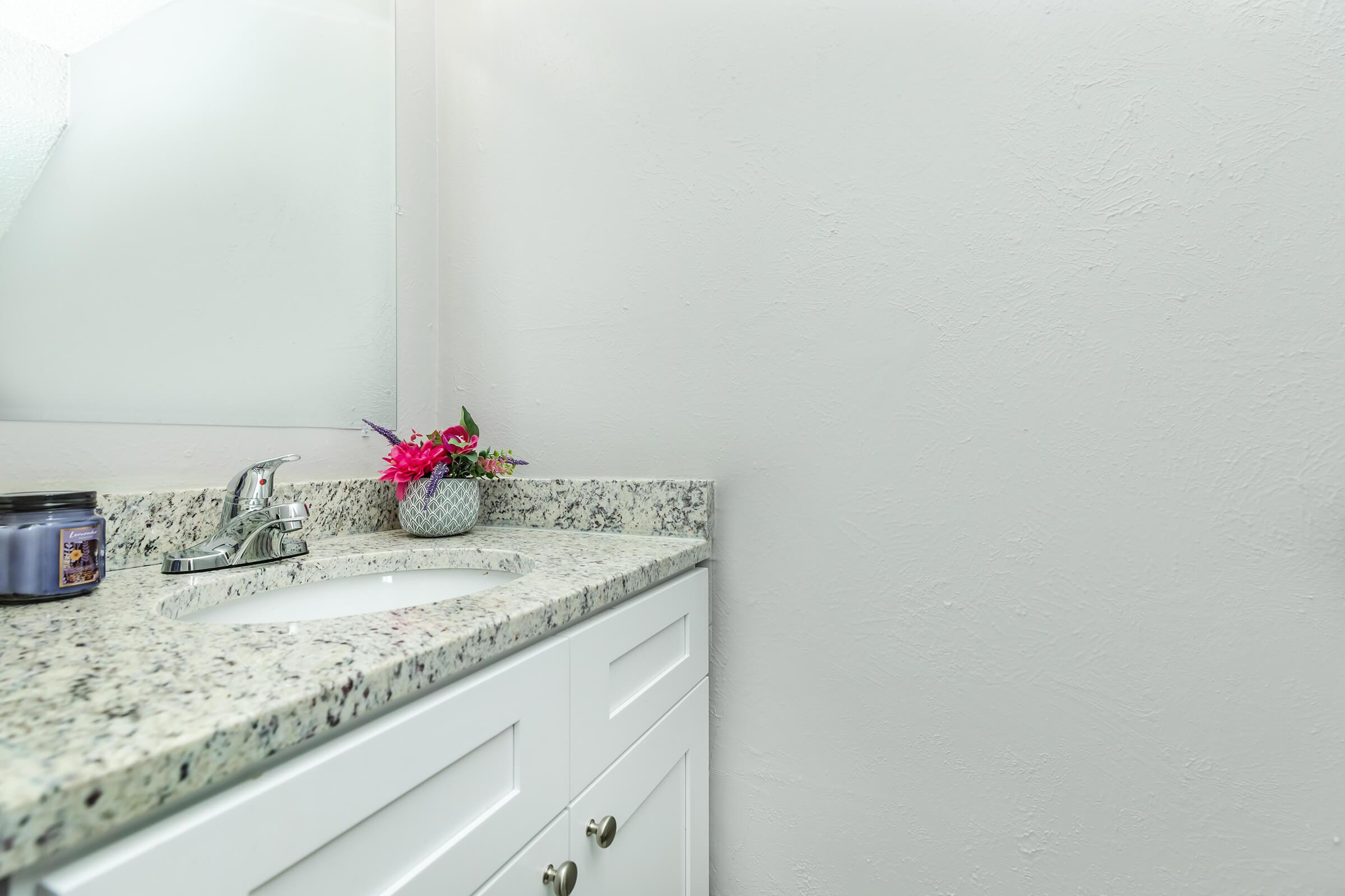 a kitchen with a sink and a mirror