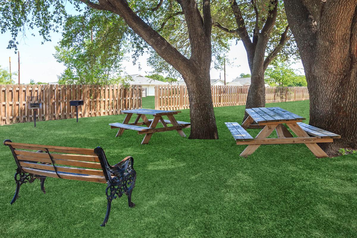 a wooden park bench sitting in the grass