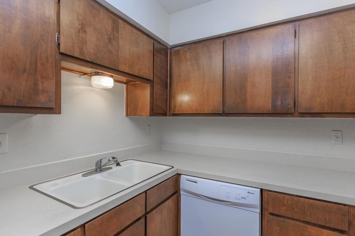 a kitchen with wooden cabinets and a sink