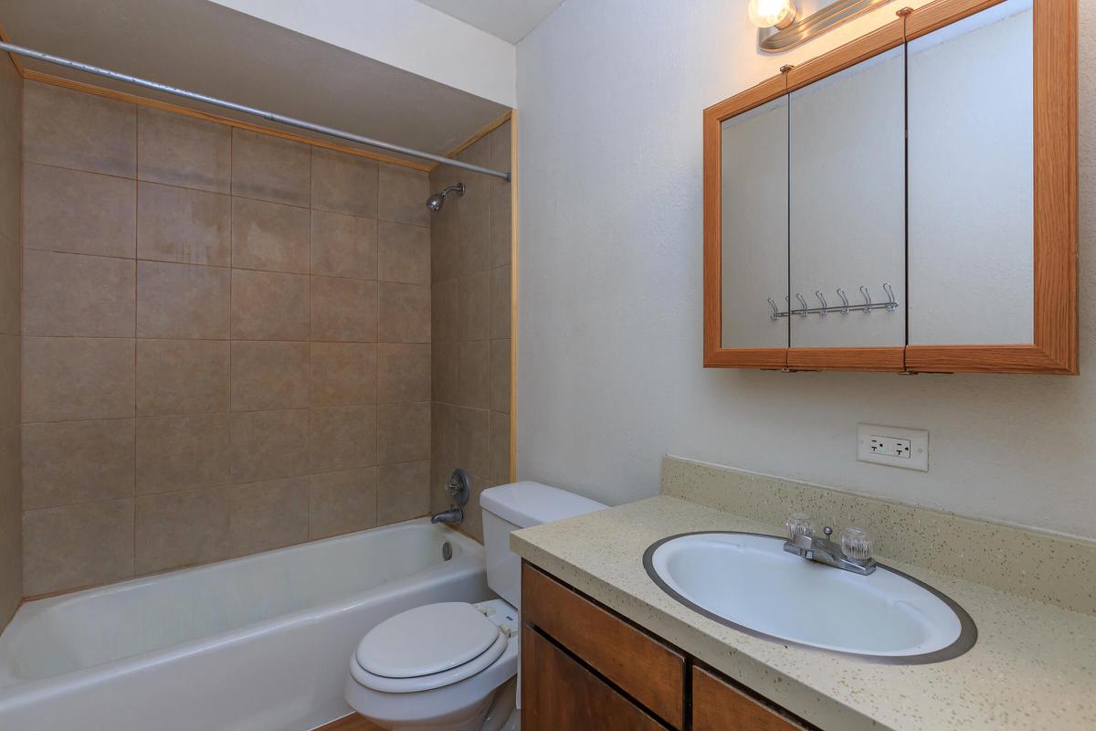 a large white tub next to a sink
