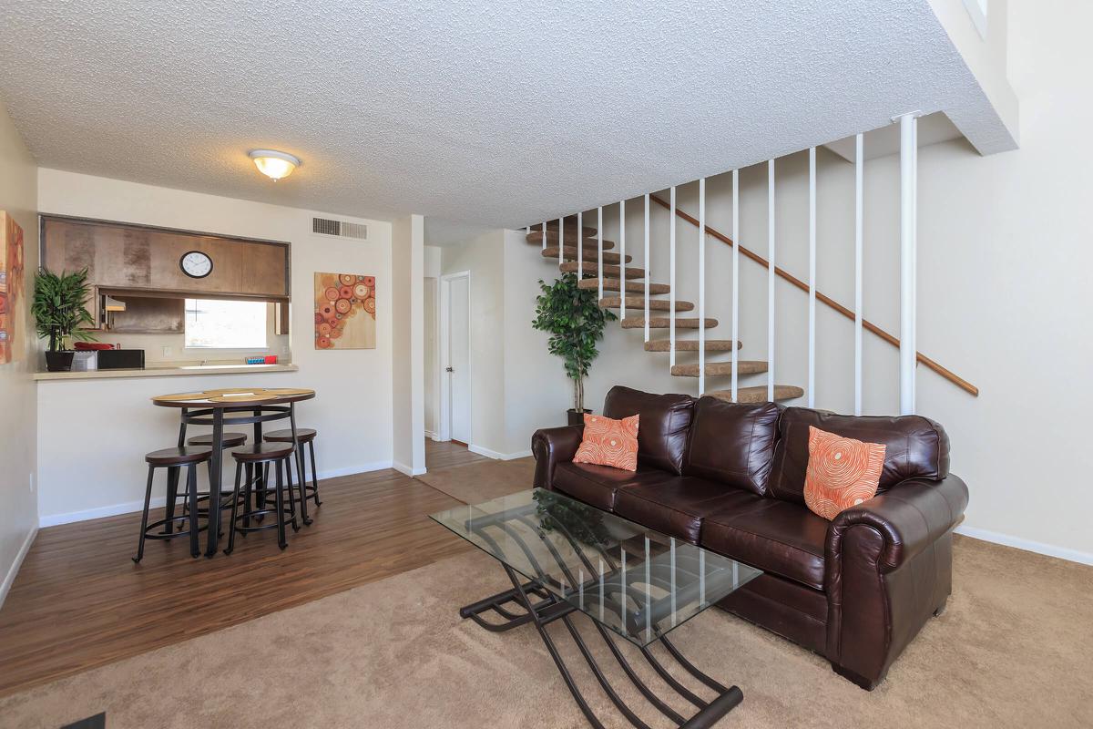 a living room filled with furniture and a flat screen tv