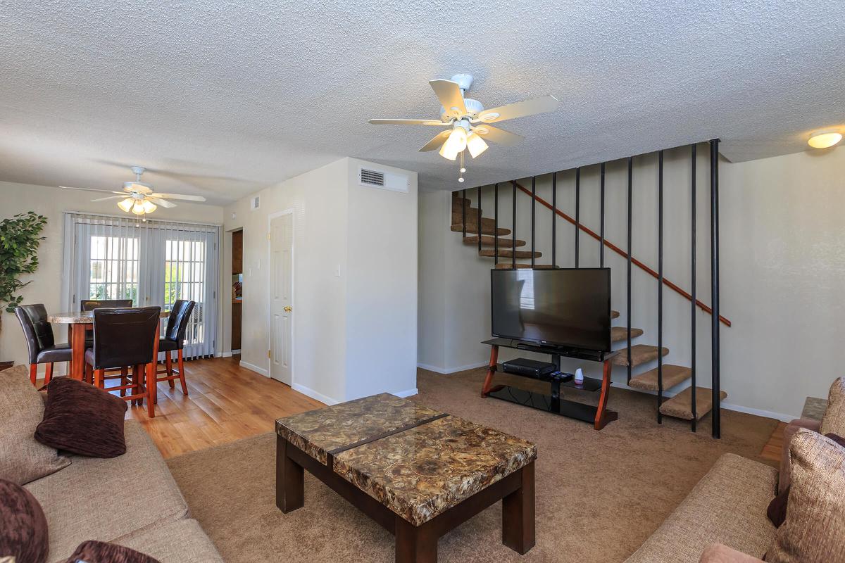 a living room filled with furniture and a flat screen tv