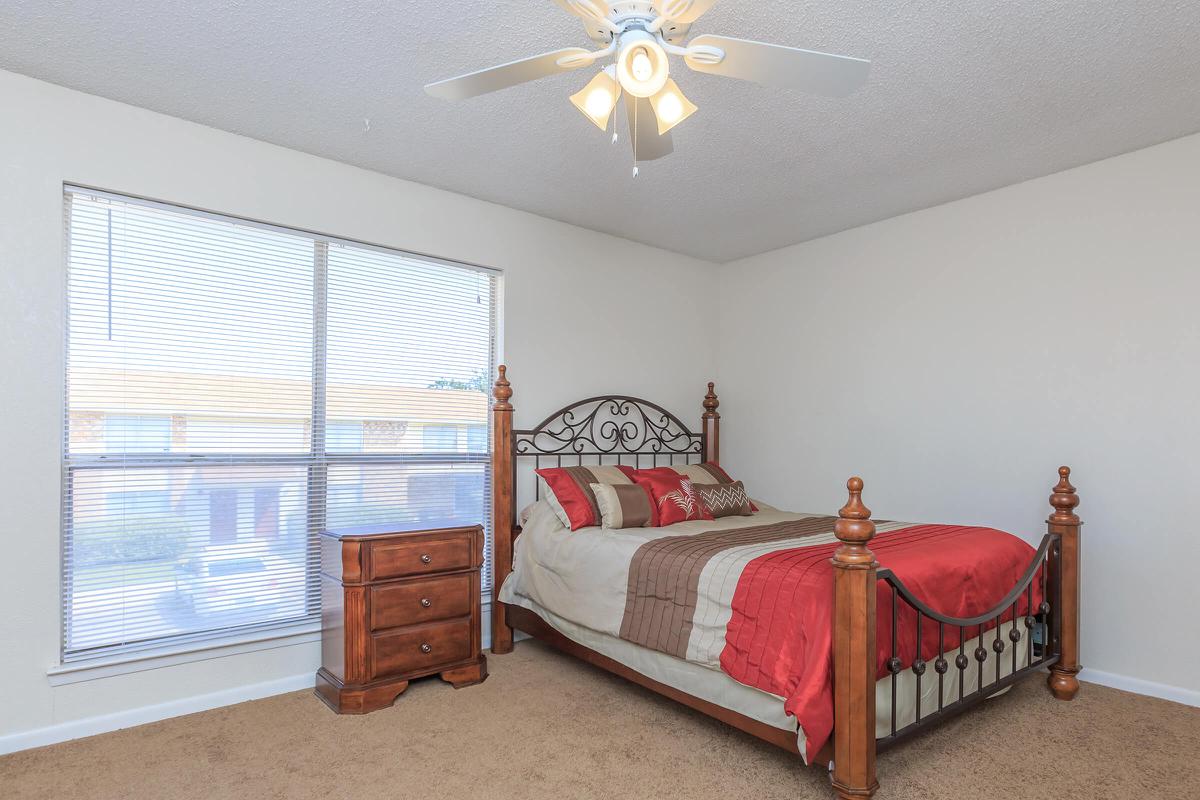 a bedroom with a bed in a room