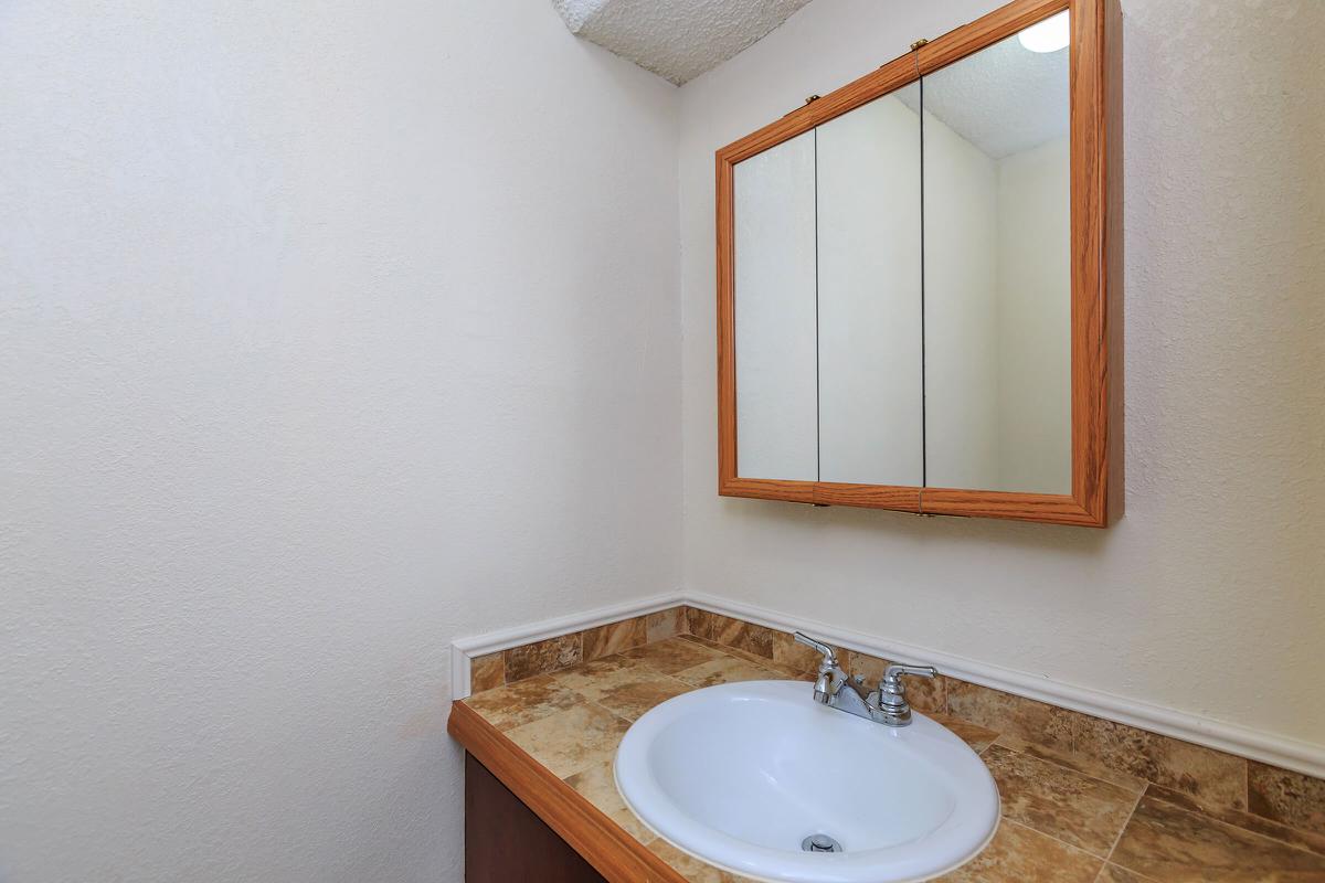 a white sink and a mirror