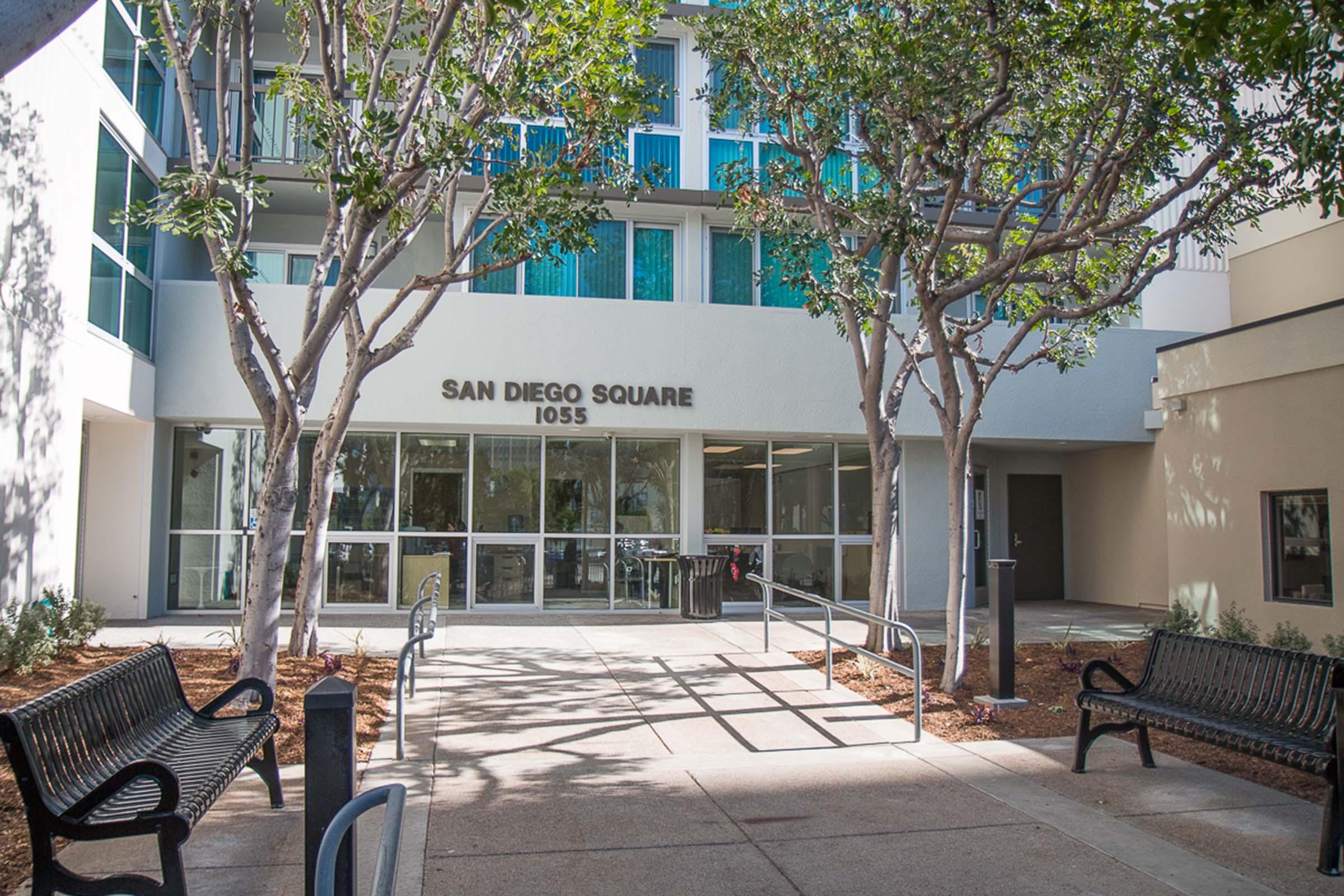 San Diego Square entrance courtyard with benches and trees.