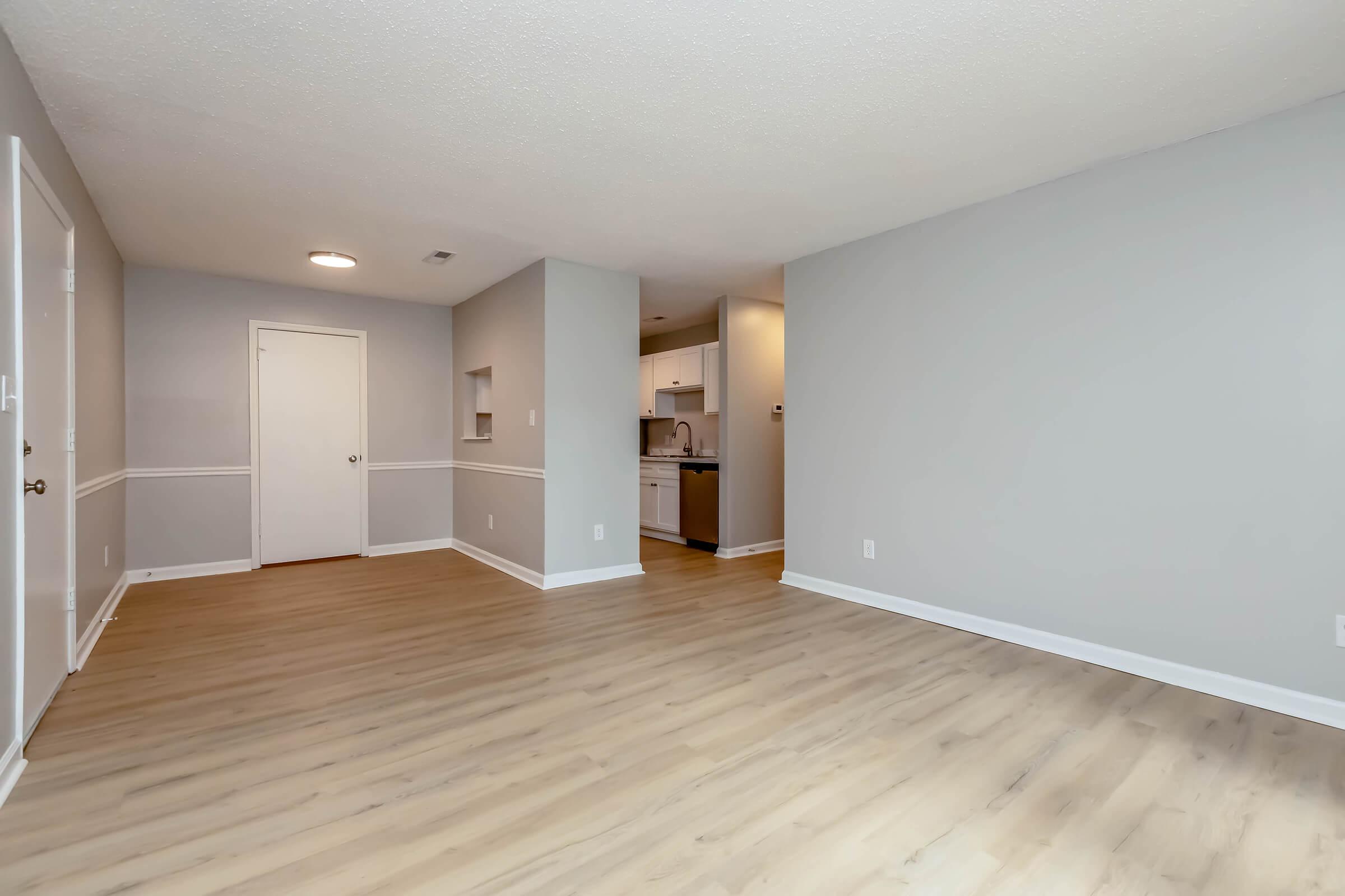 a large empty room with a wood floor