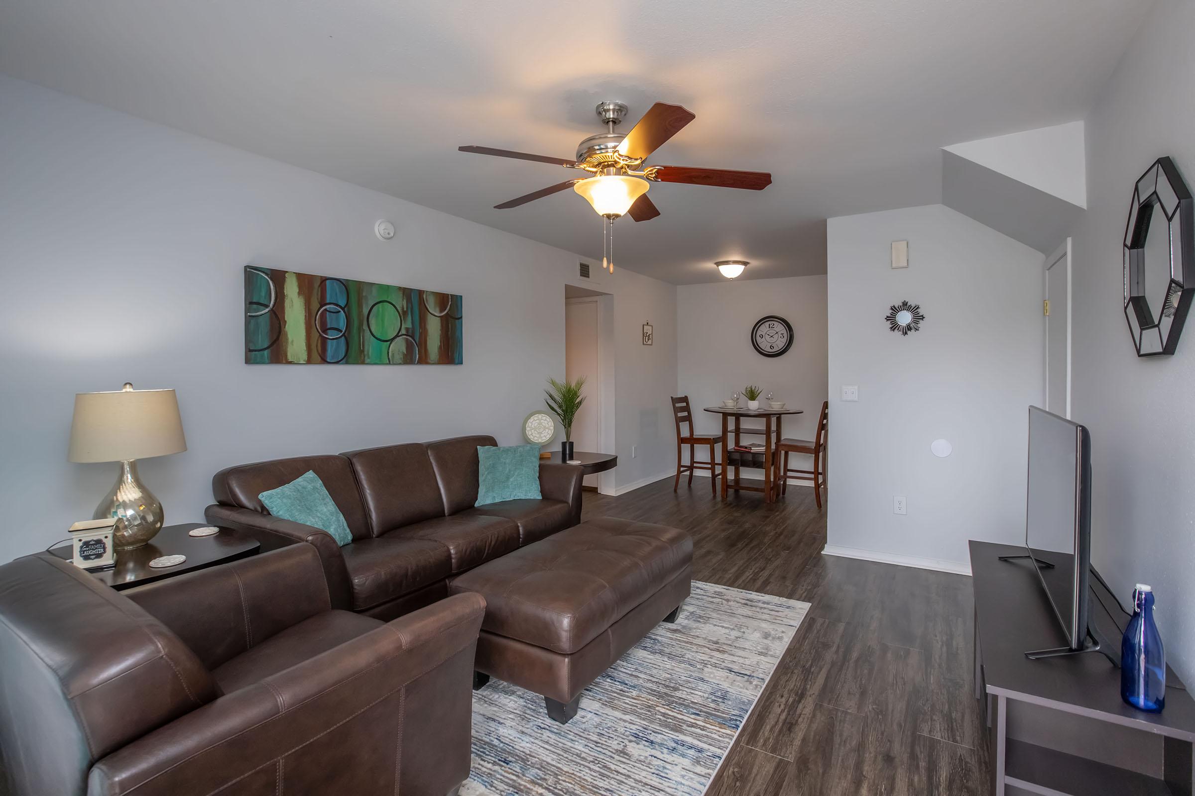 a living room filled with furniture and a flat screen tv