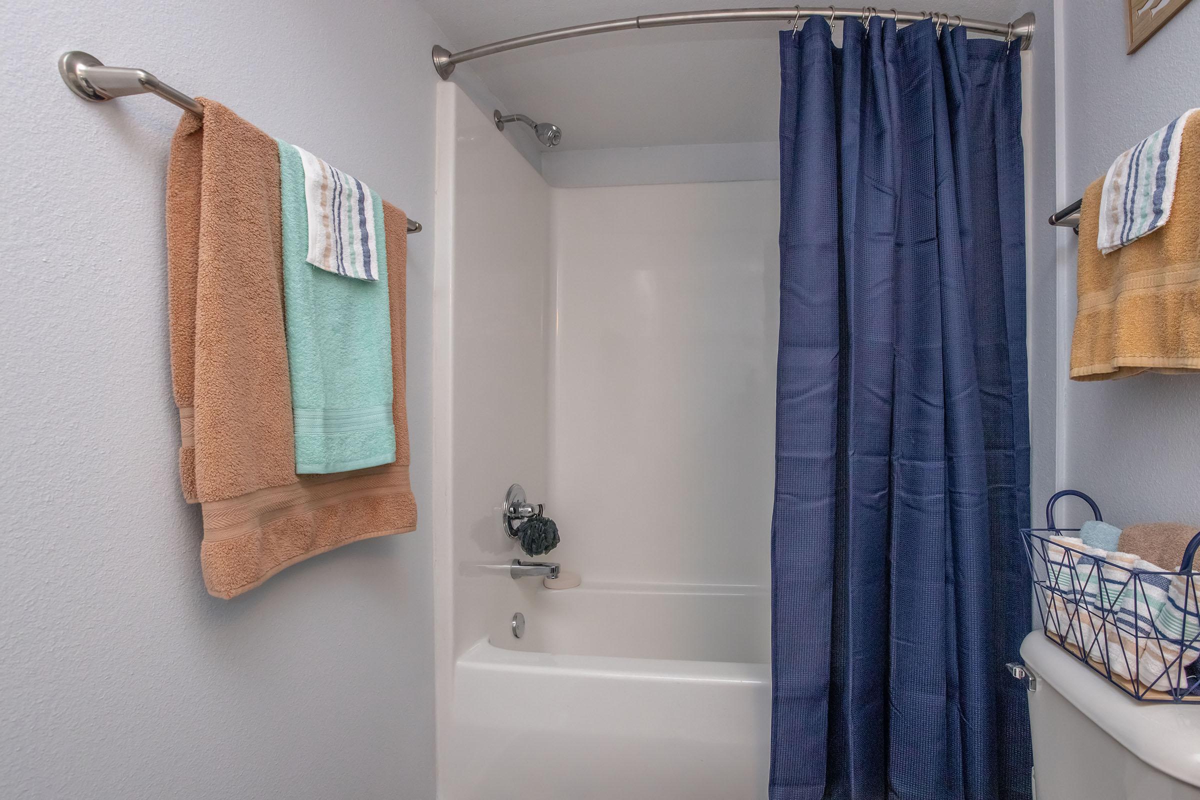 a shower curtain with a towel hanging on the wall