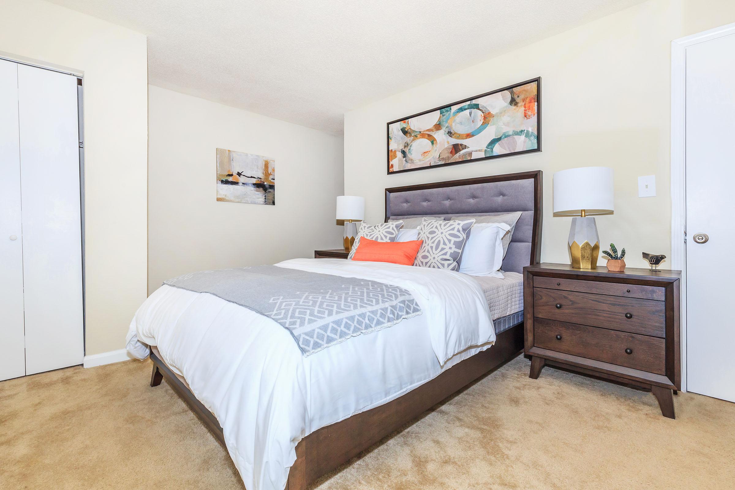 a bedroom with a bed and desk in a room