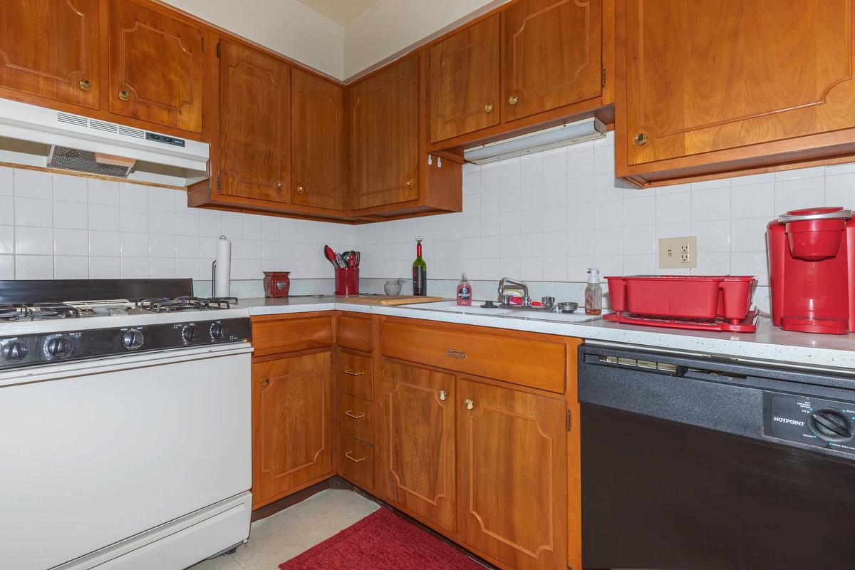 a kitchen with stainless steel appliances and wooden cabinets