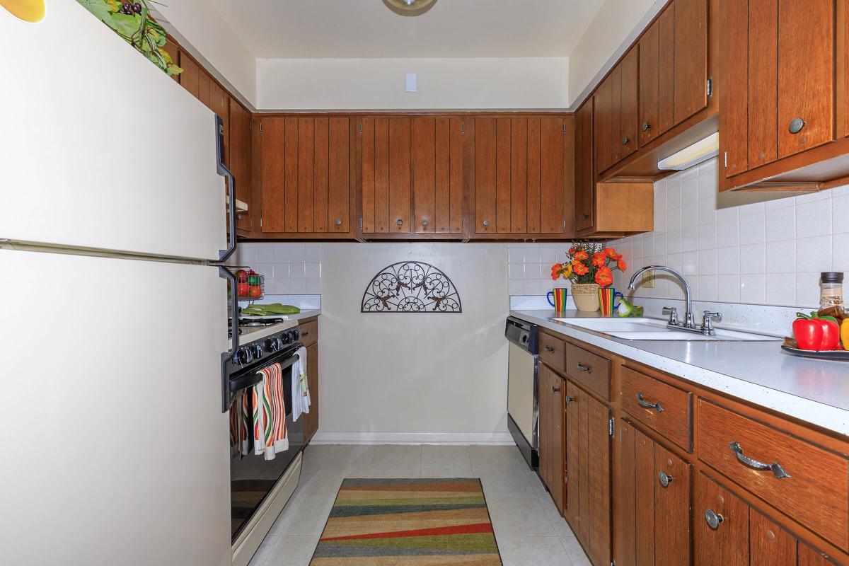 a kitchen with stainless steel appliances and wooden cabinets