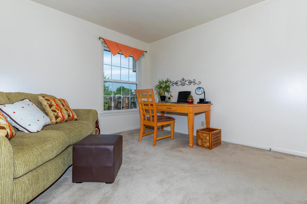 a living room filled with furniture and a bed