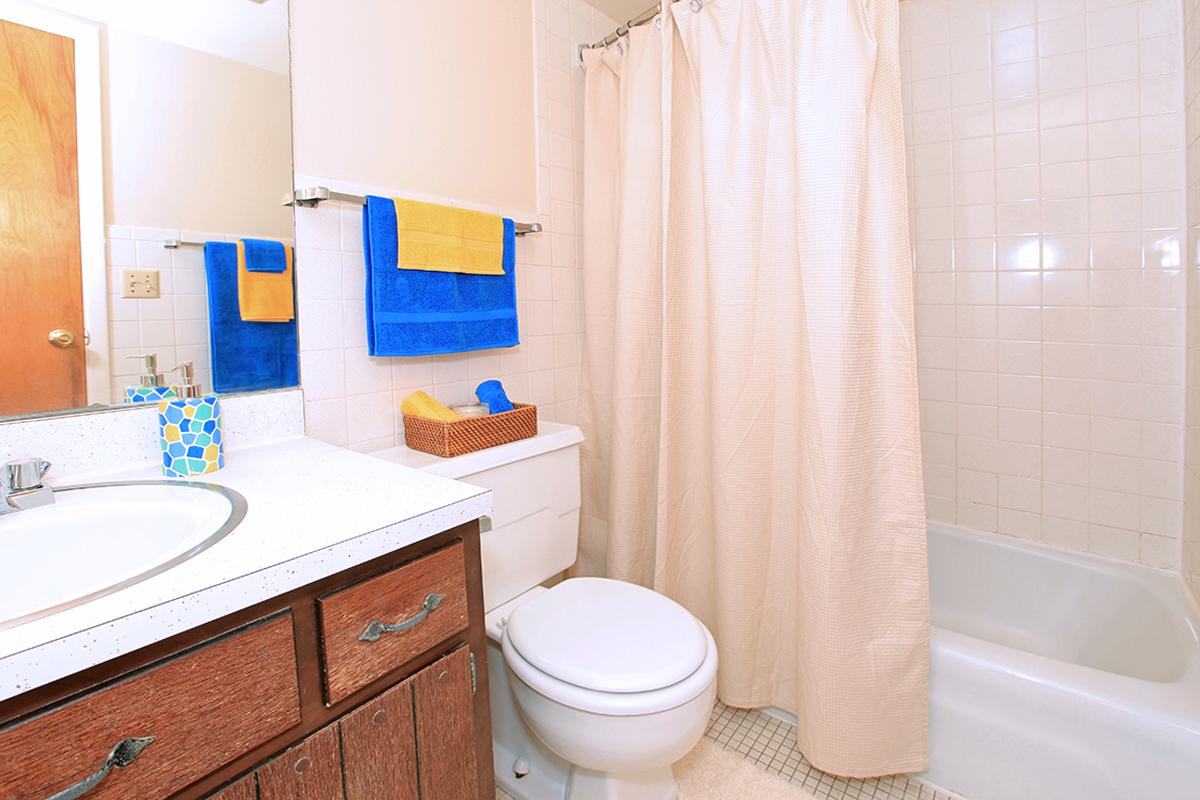 a white tub sitting next to a sink