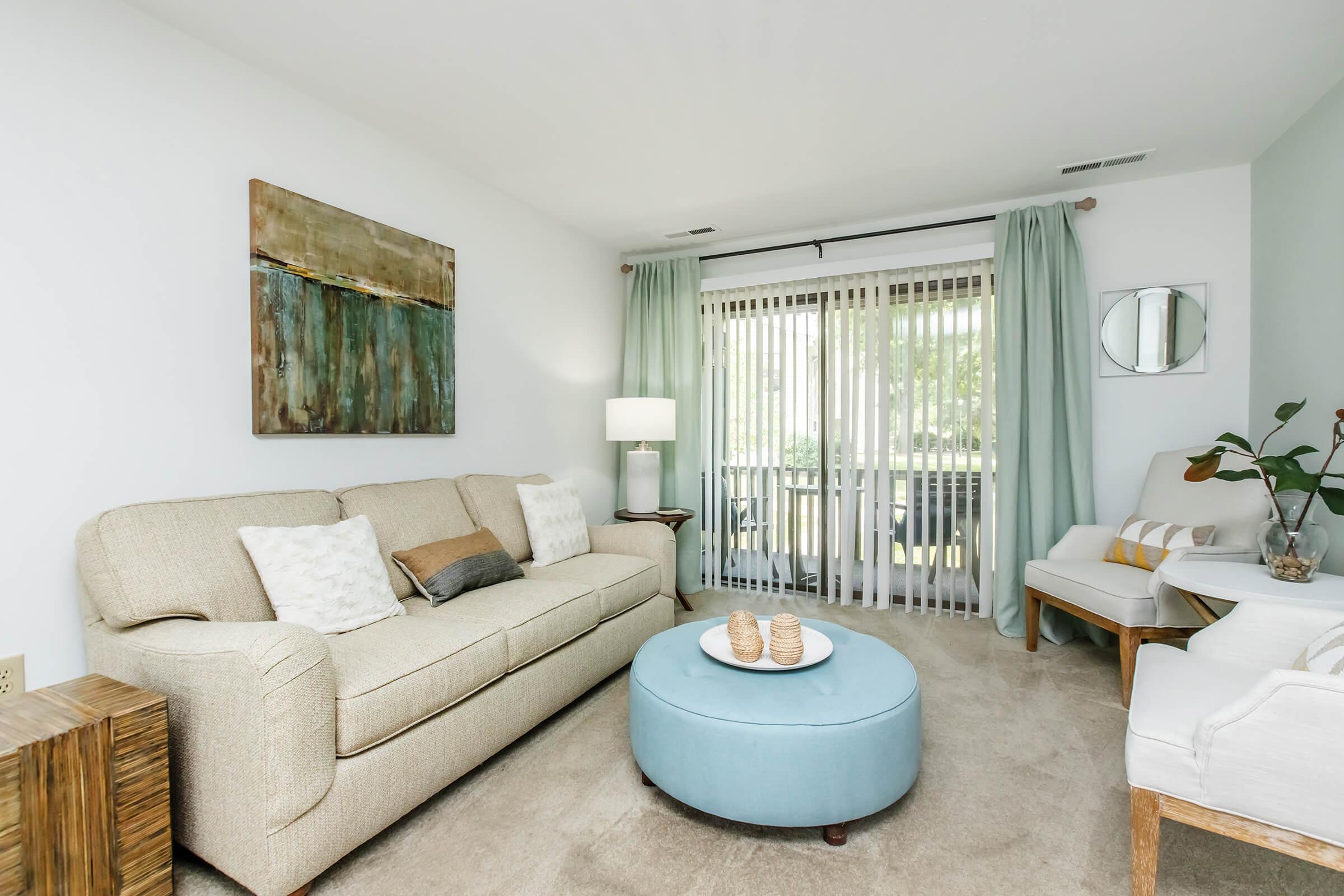 a living room filled with furniture and a flat screen tv