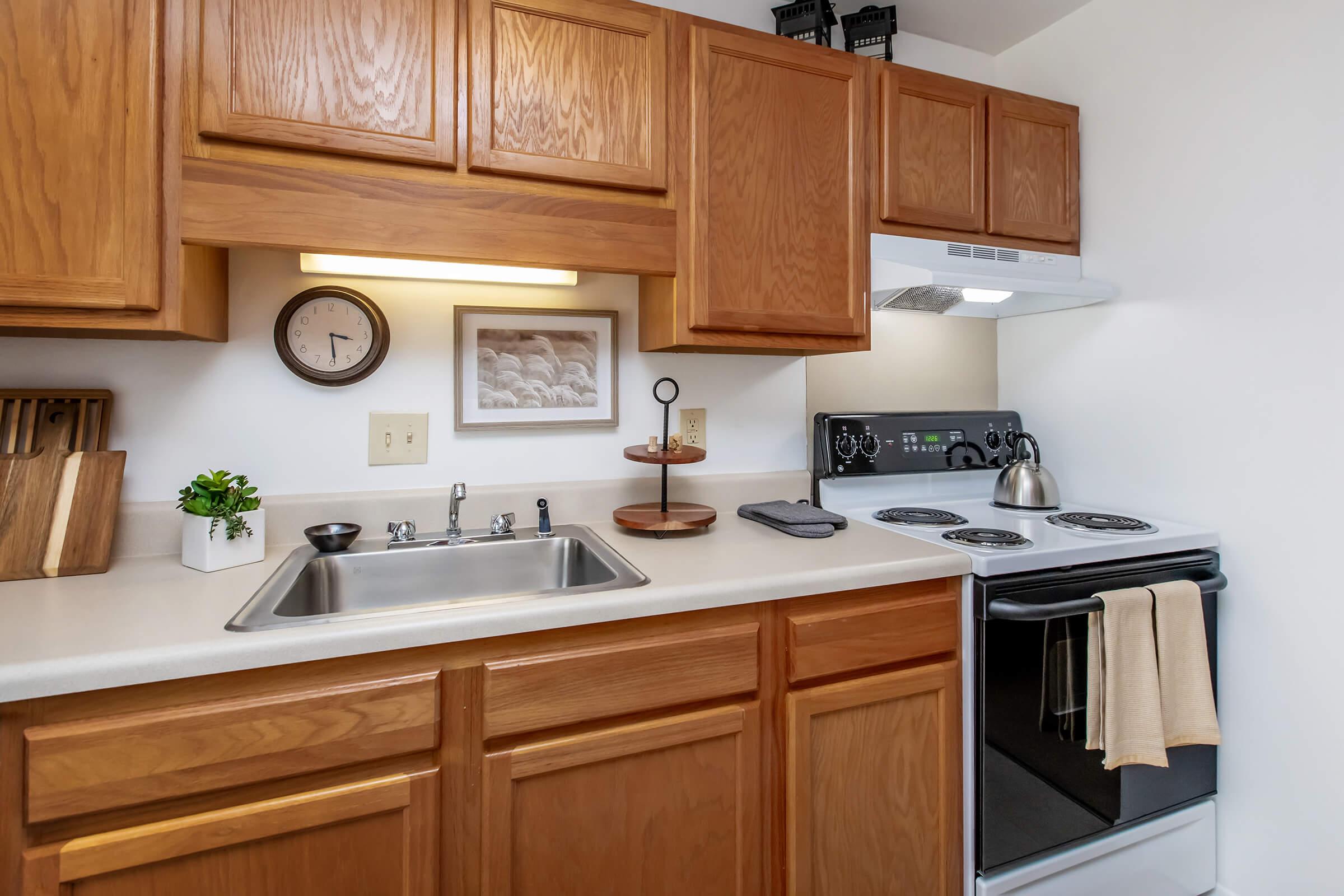 a kitchen with a stove a sink and a microwave