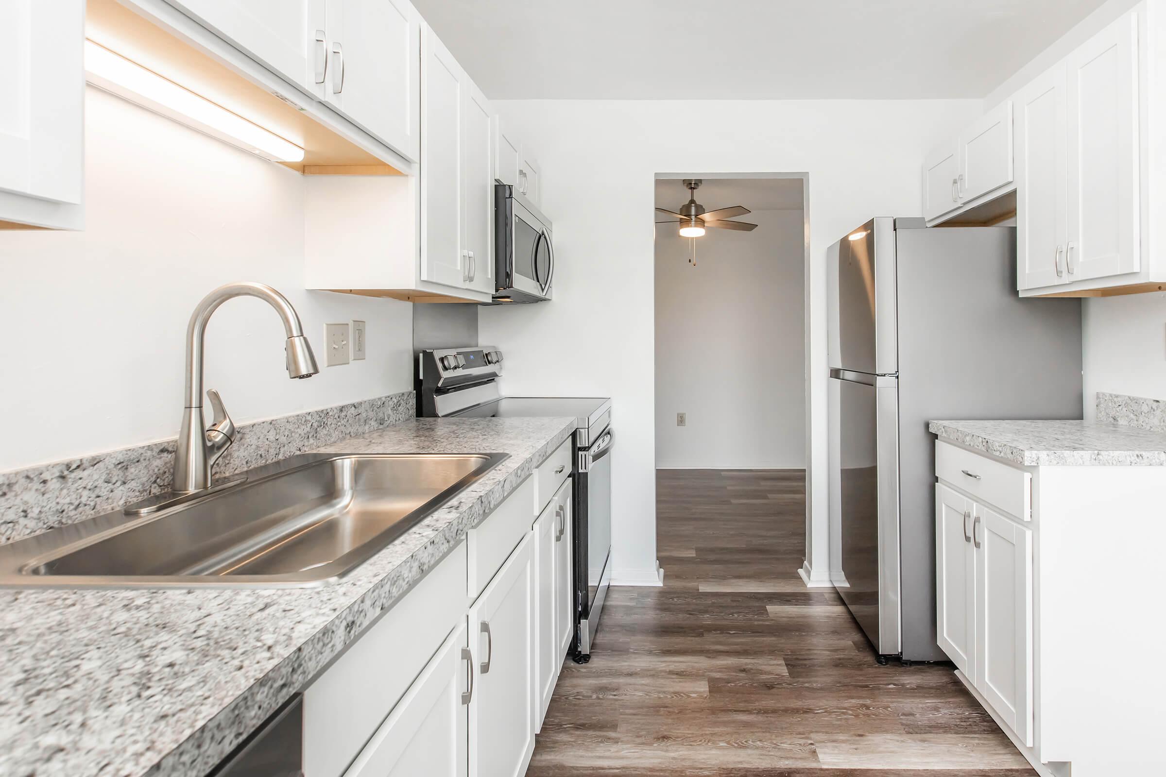 a kitchen with a sink and a refrigerator