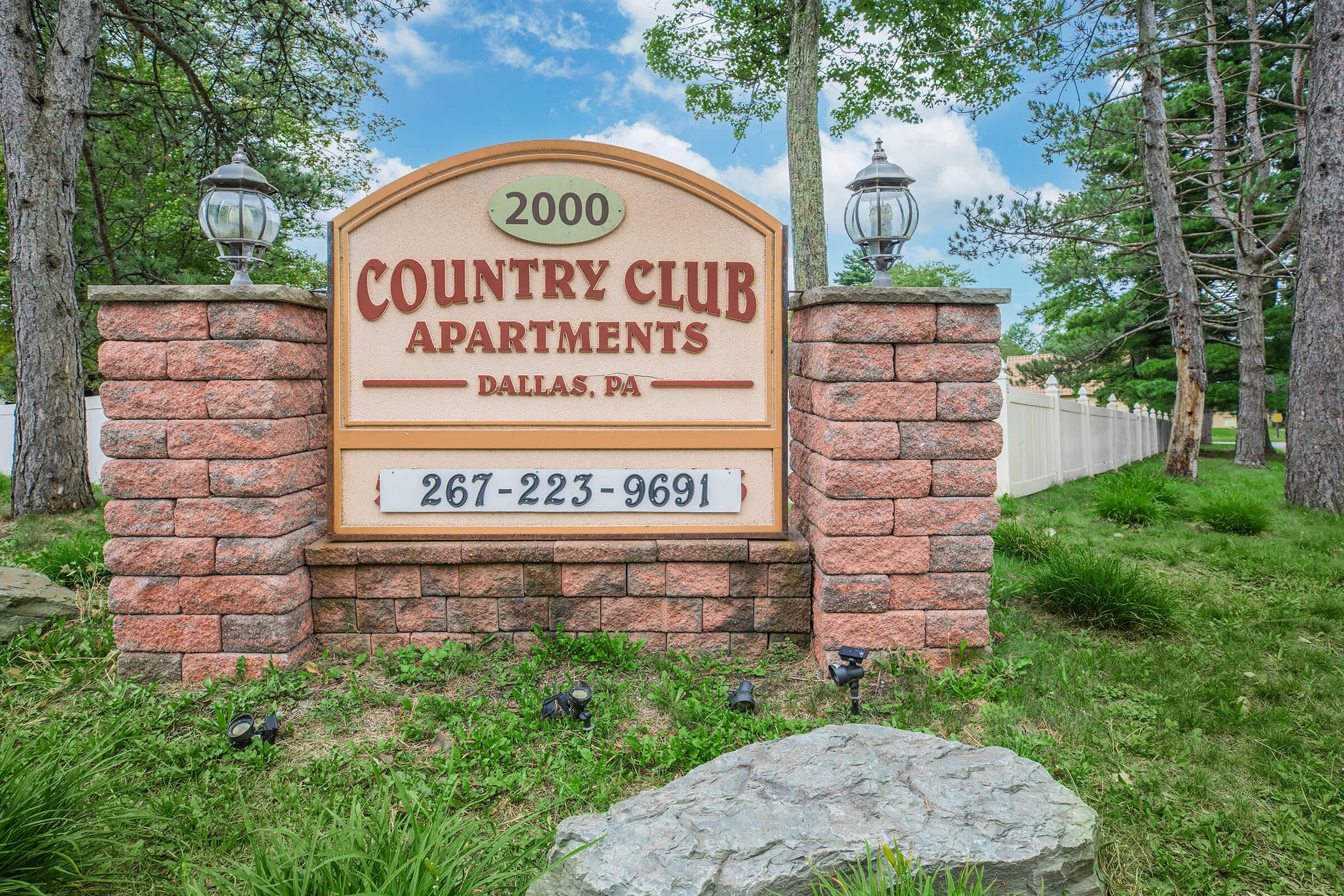 a sign in front of a brick building