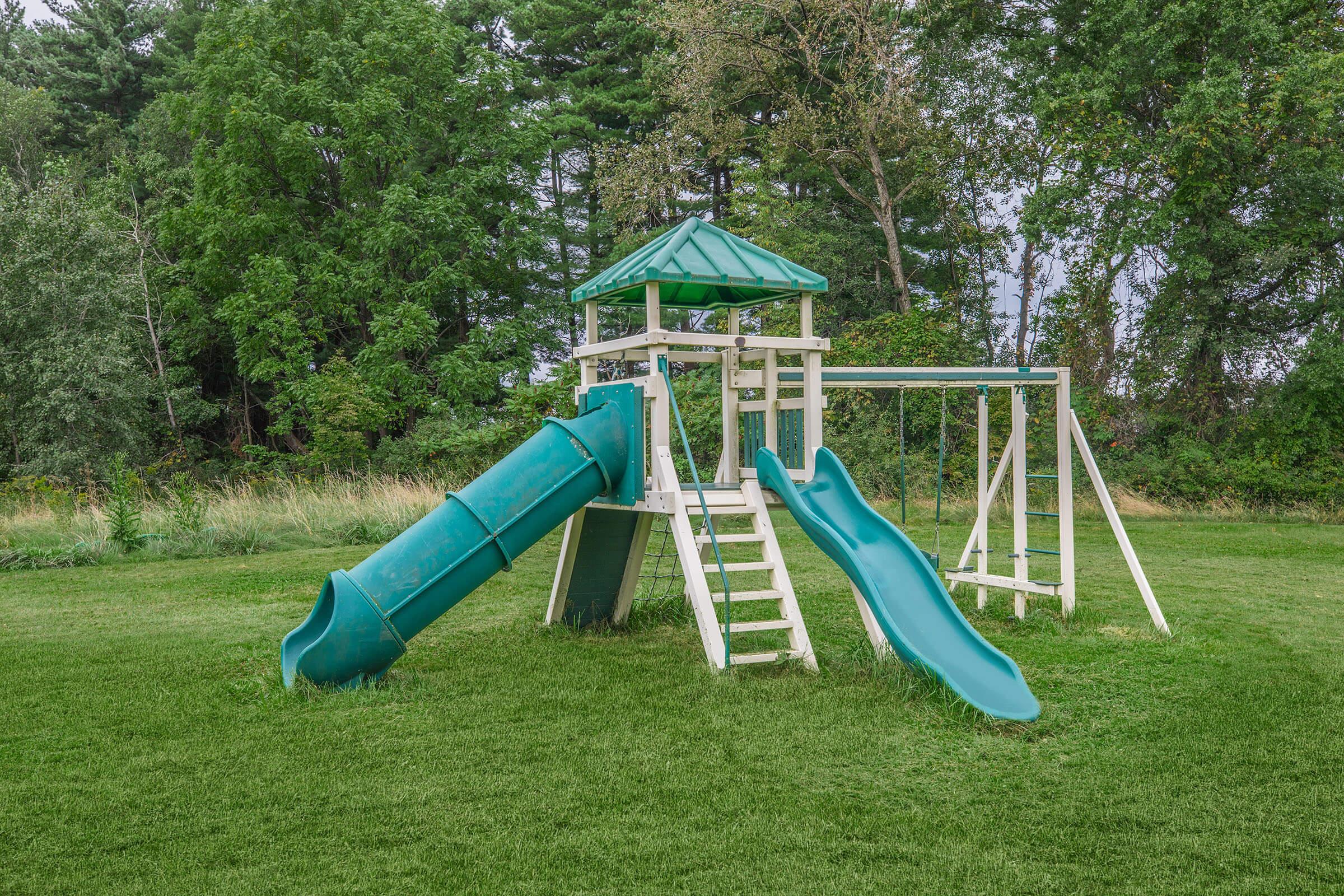 a green lawn chair on a playground