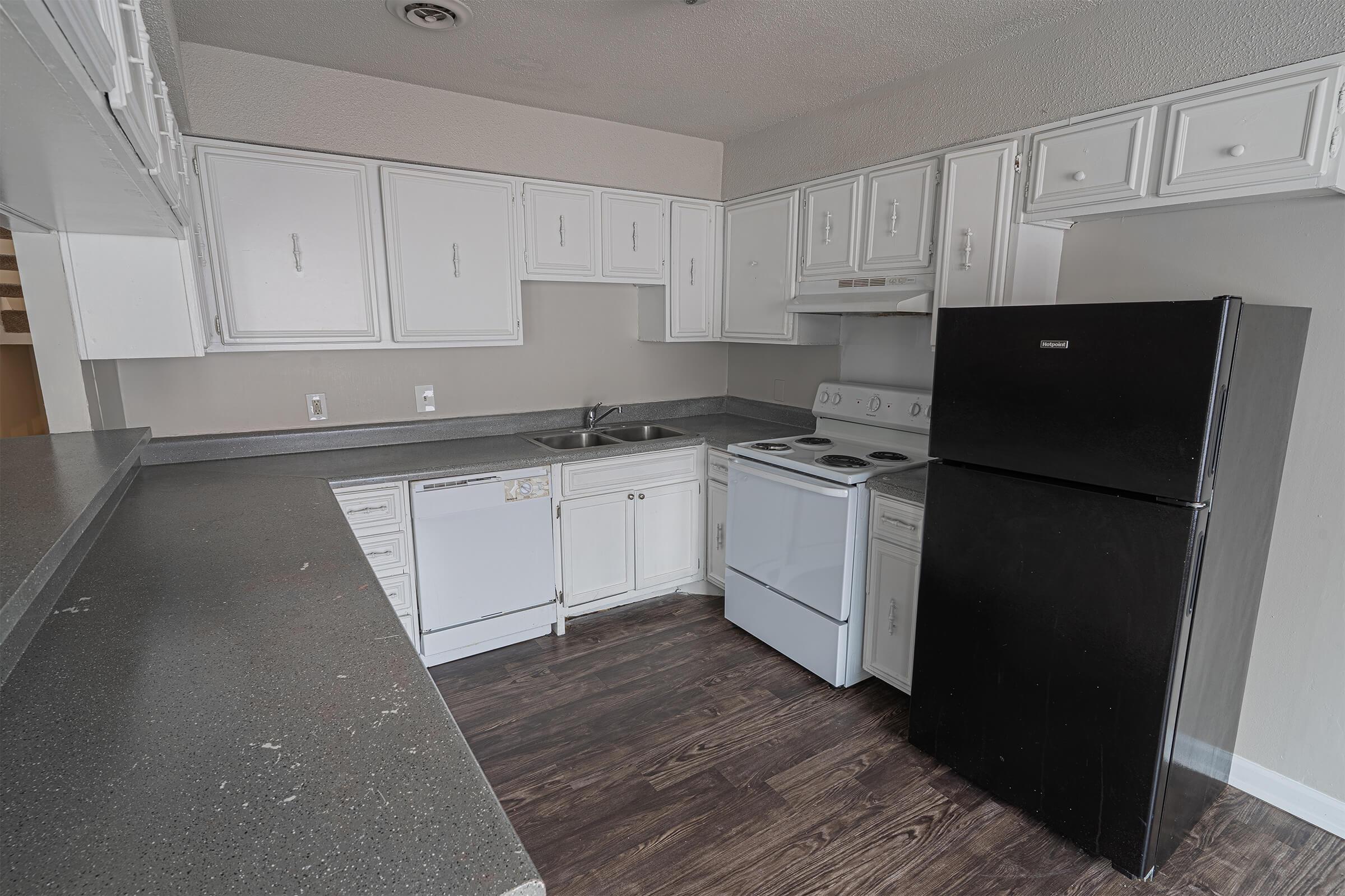 a kitchen with a stove and a refrigerator