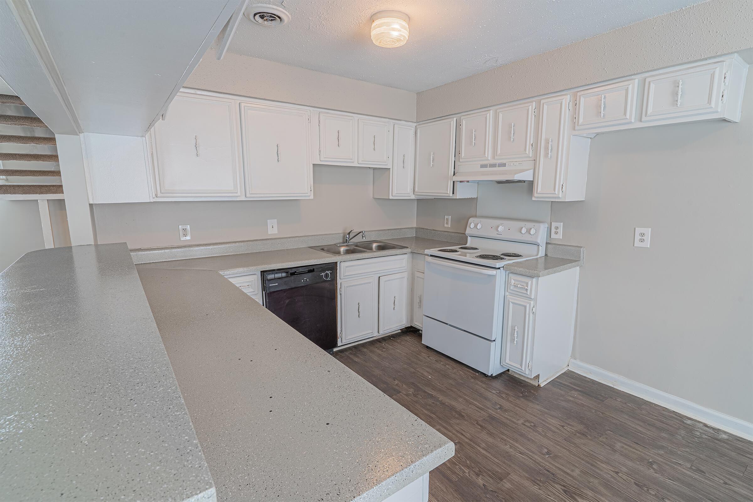 a kitchen with a stove and a refrigerator