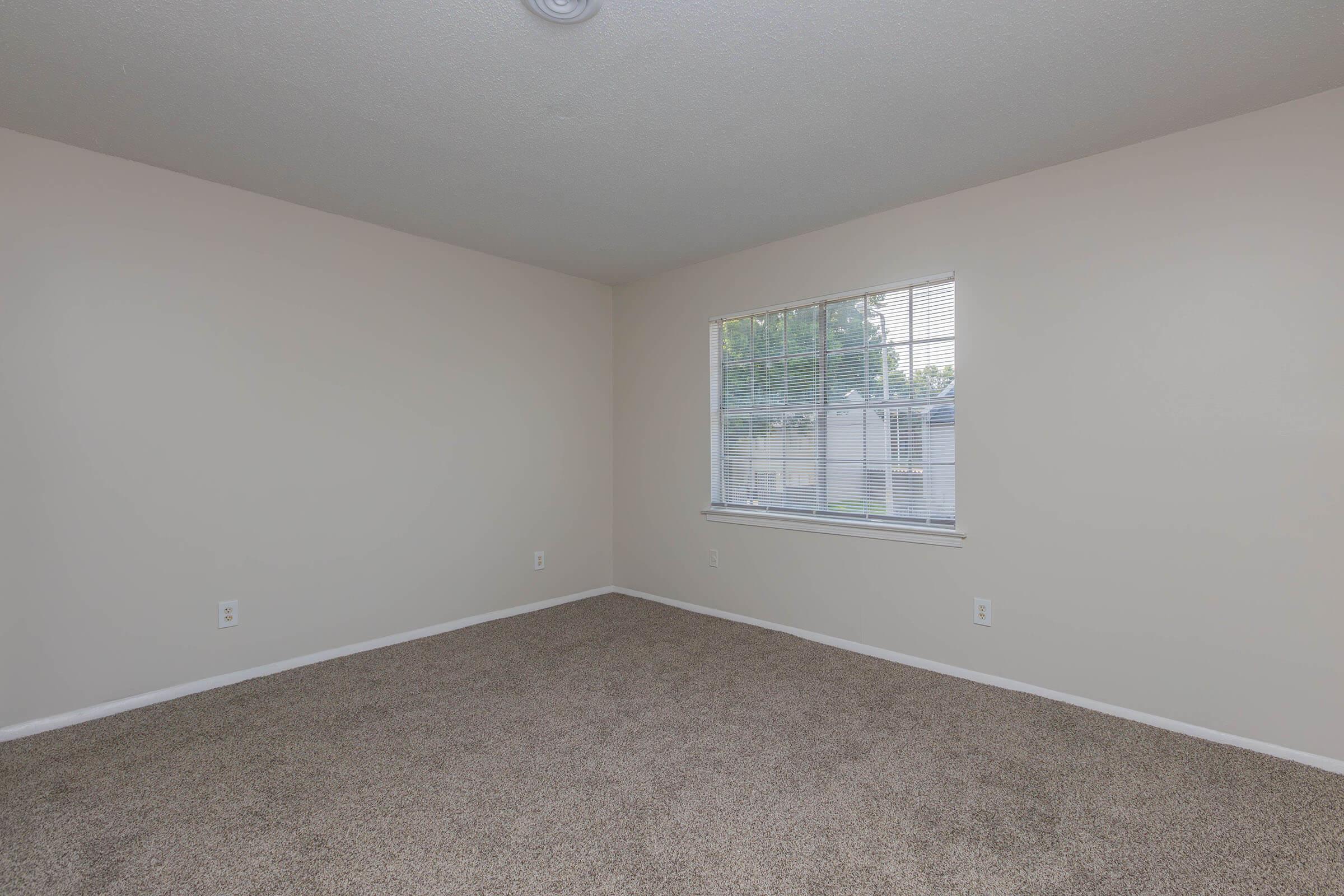 a bedroom with a large window