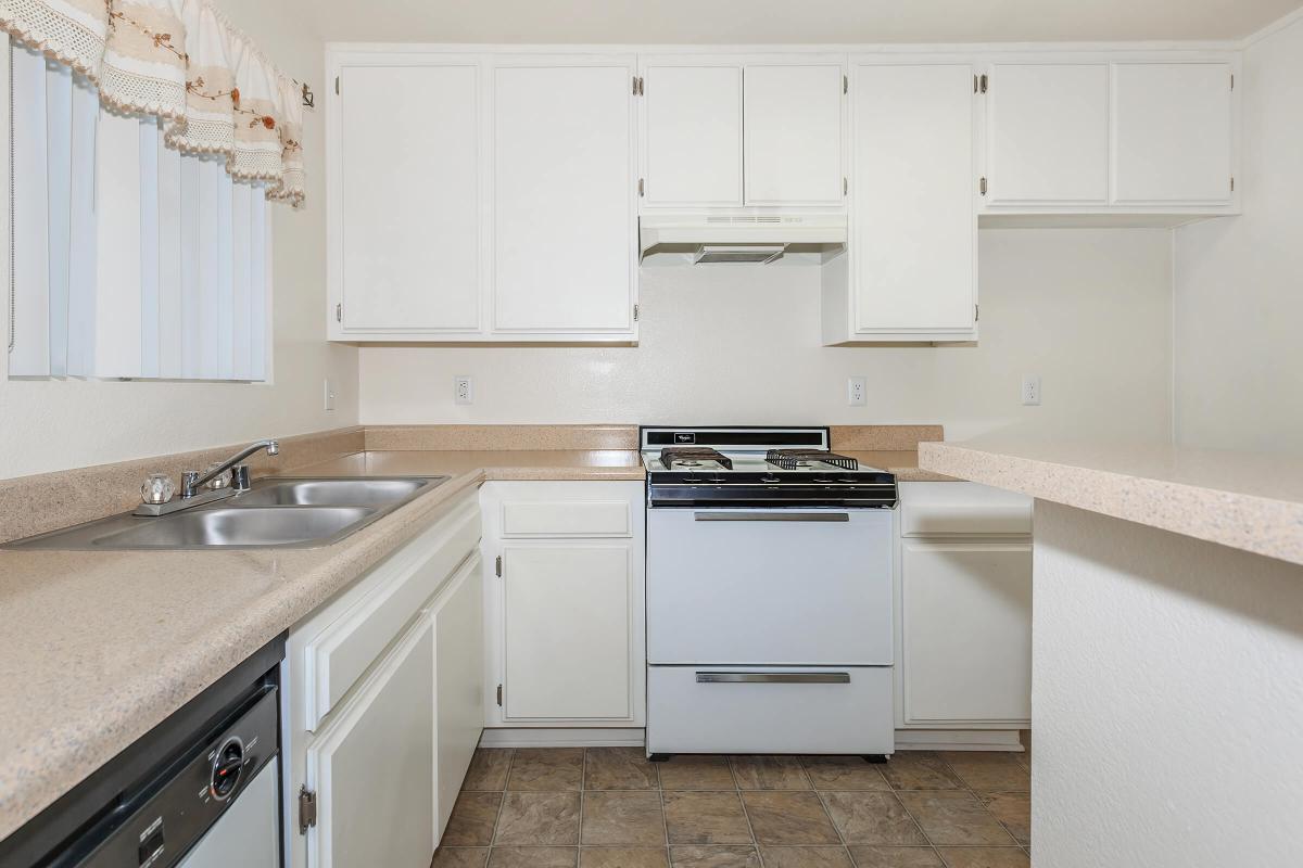 a white stove top oven sitting inside of a kitchen