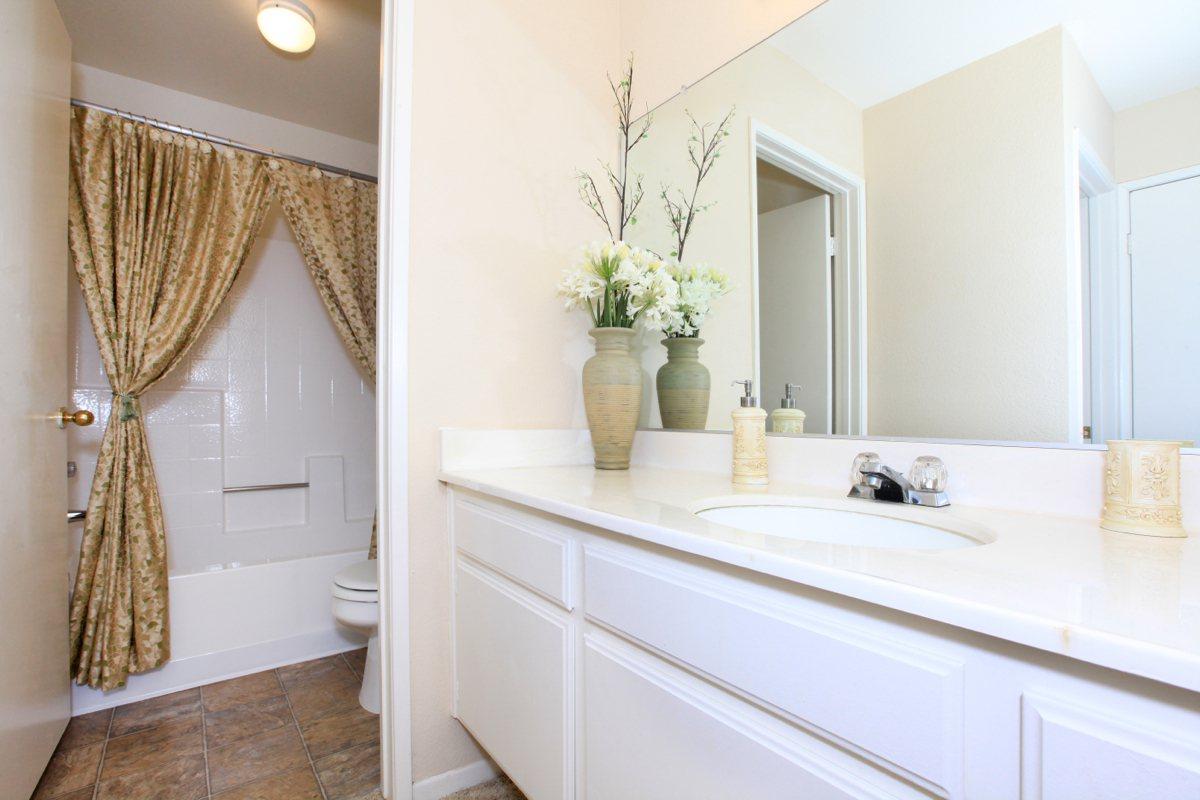 a kitchen with a sink and a mirror