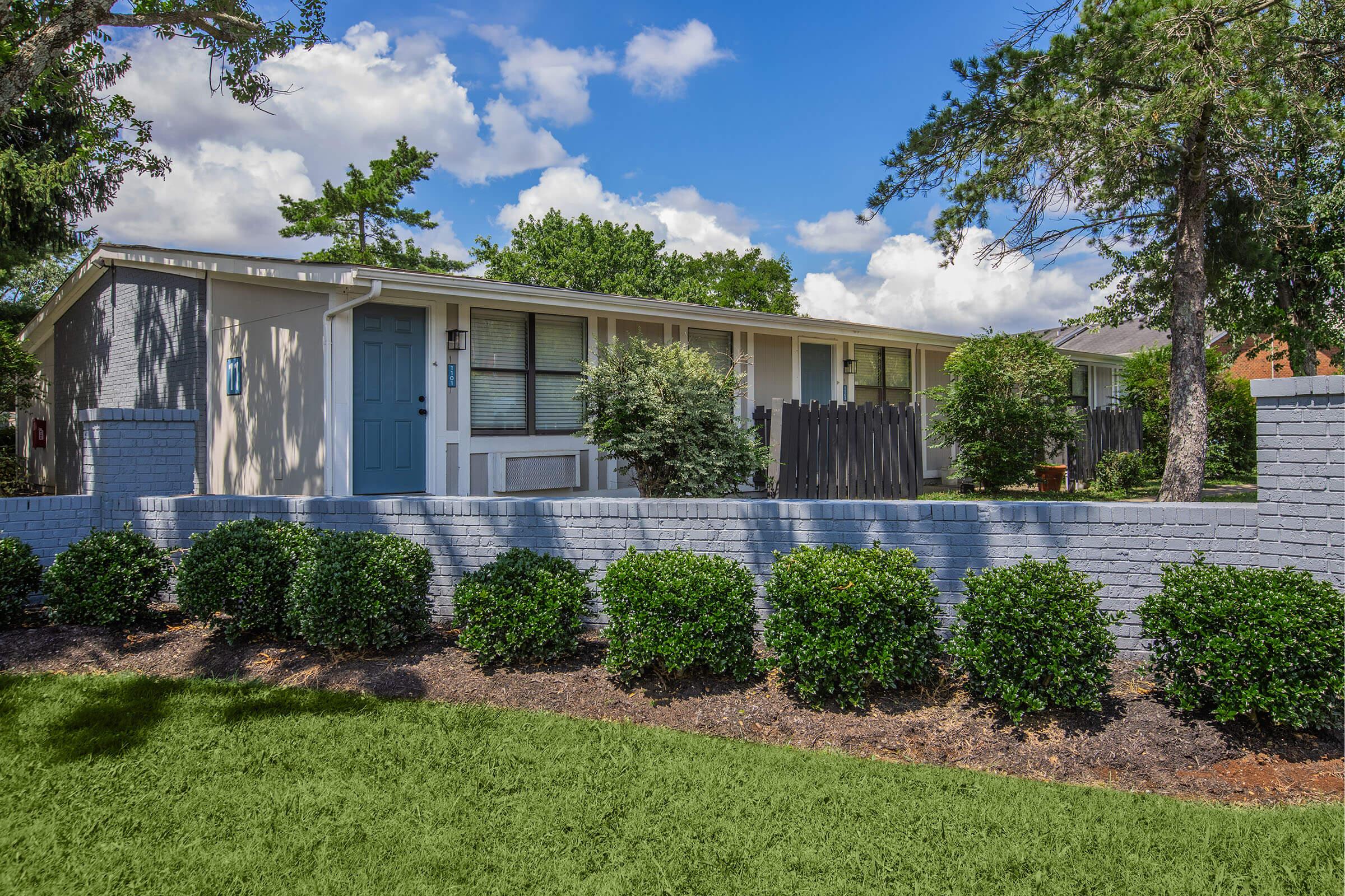 a house with bushes in front of a building