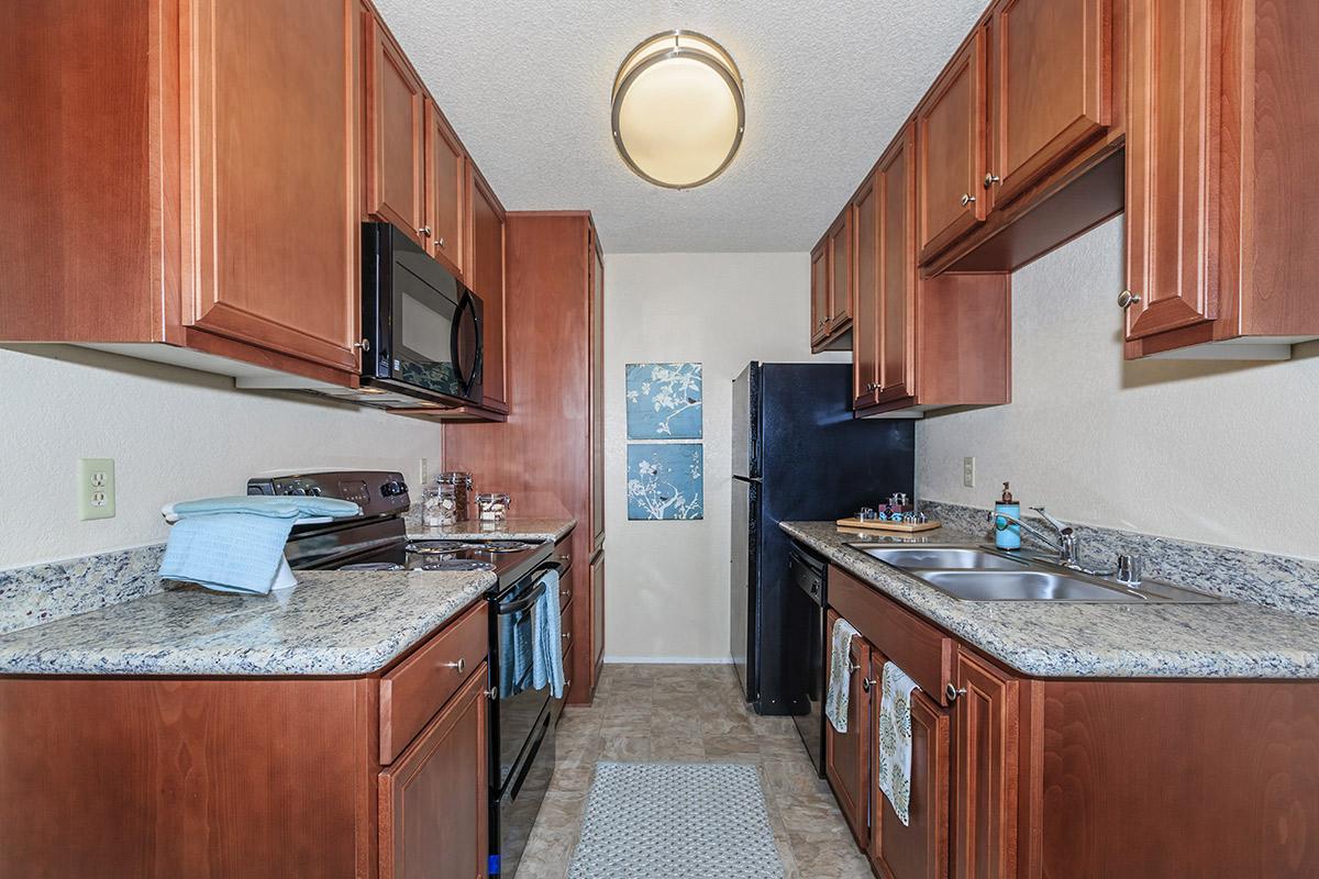 a kitchen with stainless steel appliances and wooden cabinets