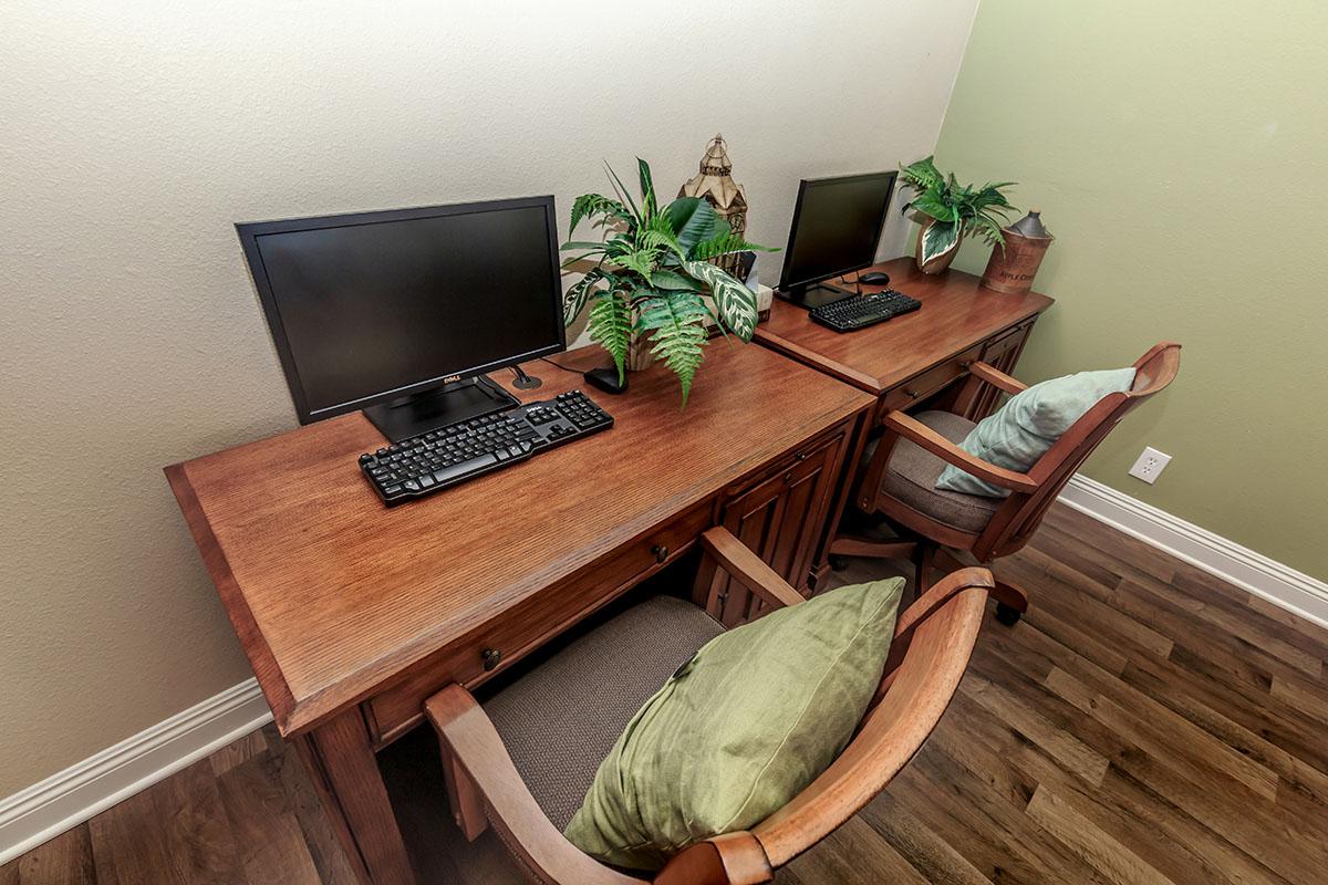 a laptop computer sitting on top of a wooden table