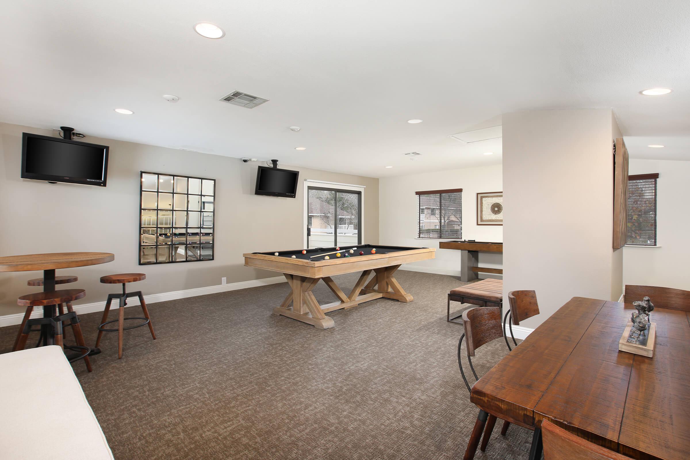 a living room filled with furniture and a flat screen tv