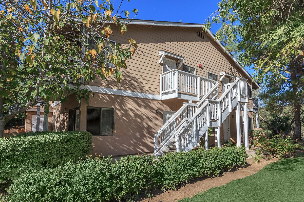 a house with bushes in front of a building